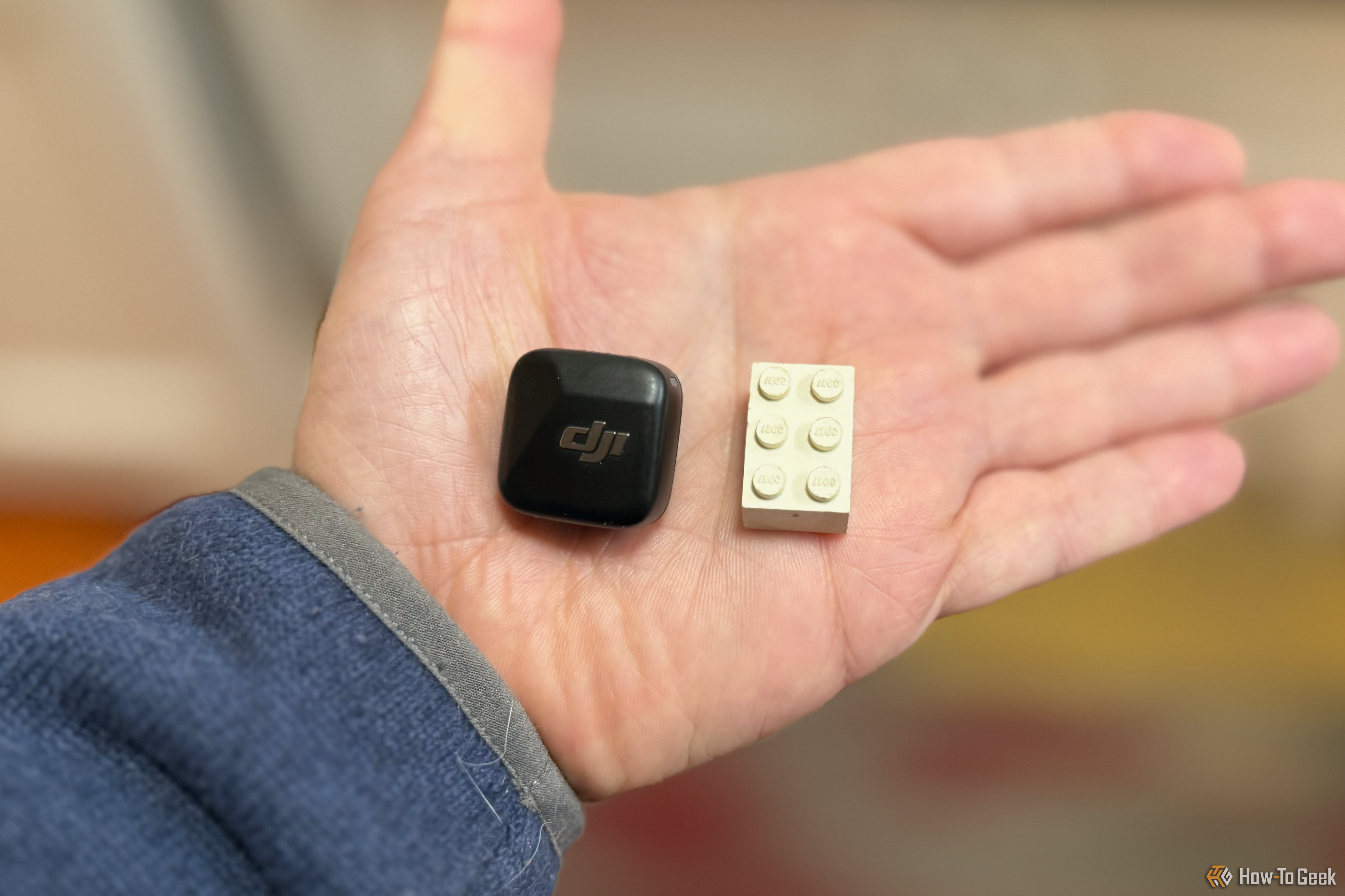 The microphone and a 3 x 2 Lego brick for comparison in a person's hand.