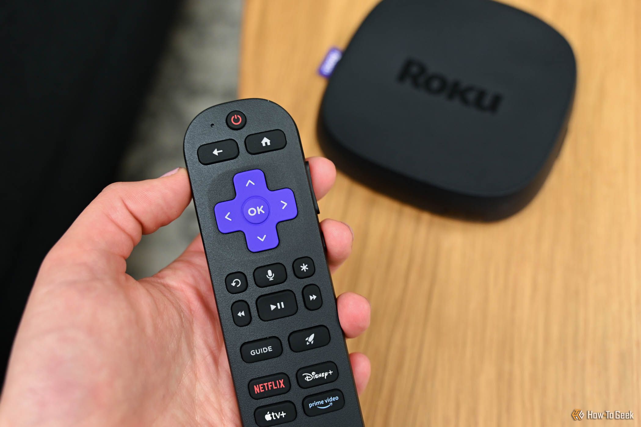 Person using the Voice Remote Pro with the Roku Ultra.