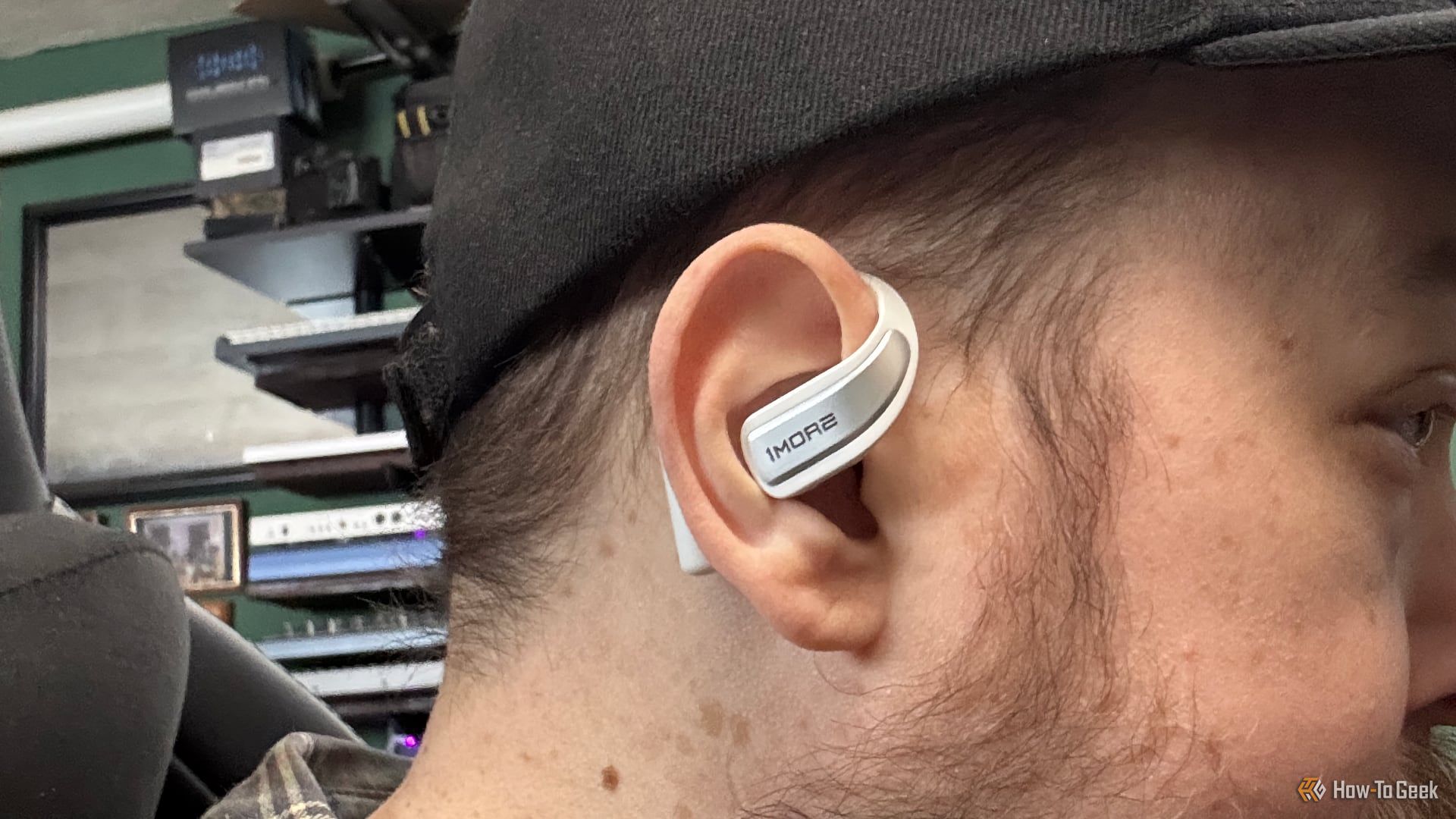 Person wearing the 1MORE S70 open earbuds.