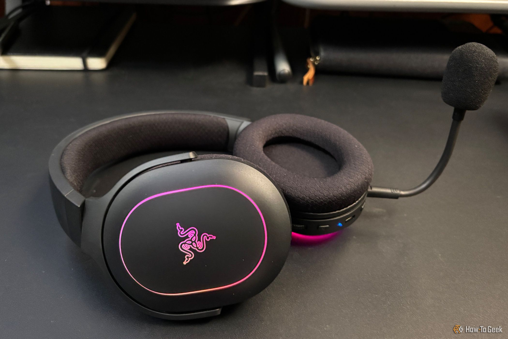 Razer Barracuda X Chroma on a desk with the microphone attached.