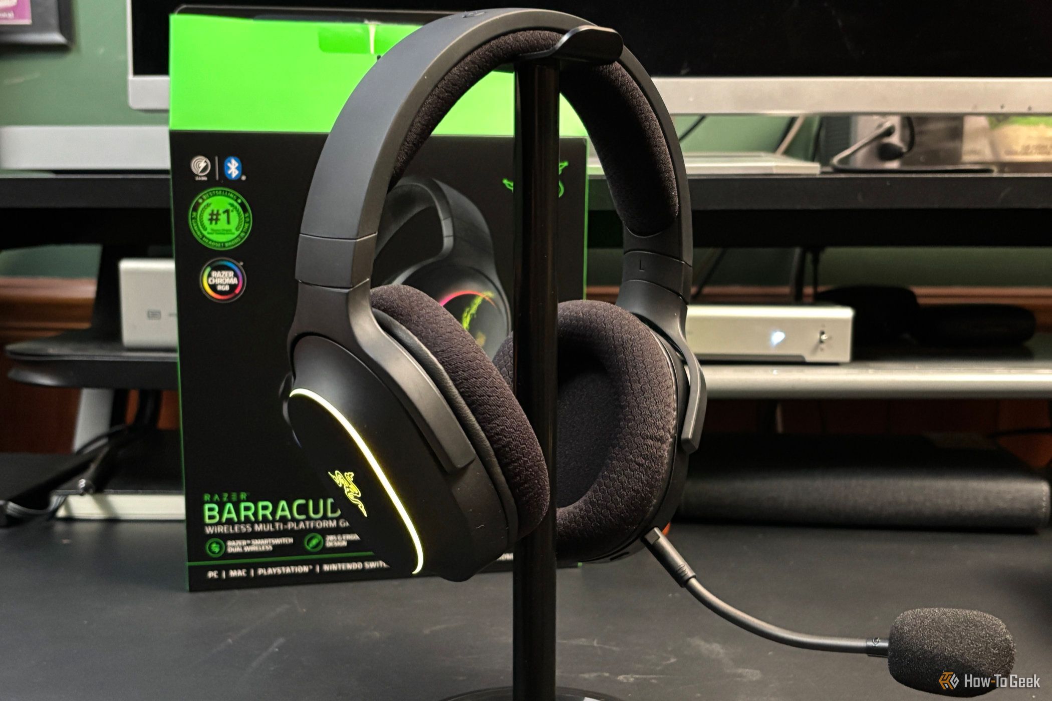 Razer Barracuda X Chroma on a headphone stand with the microphone attached