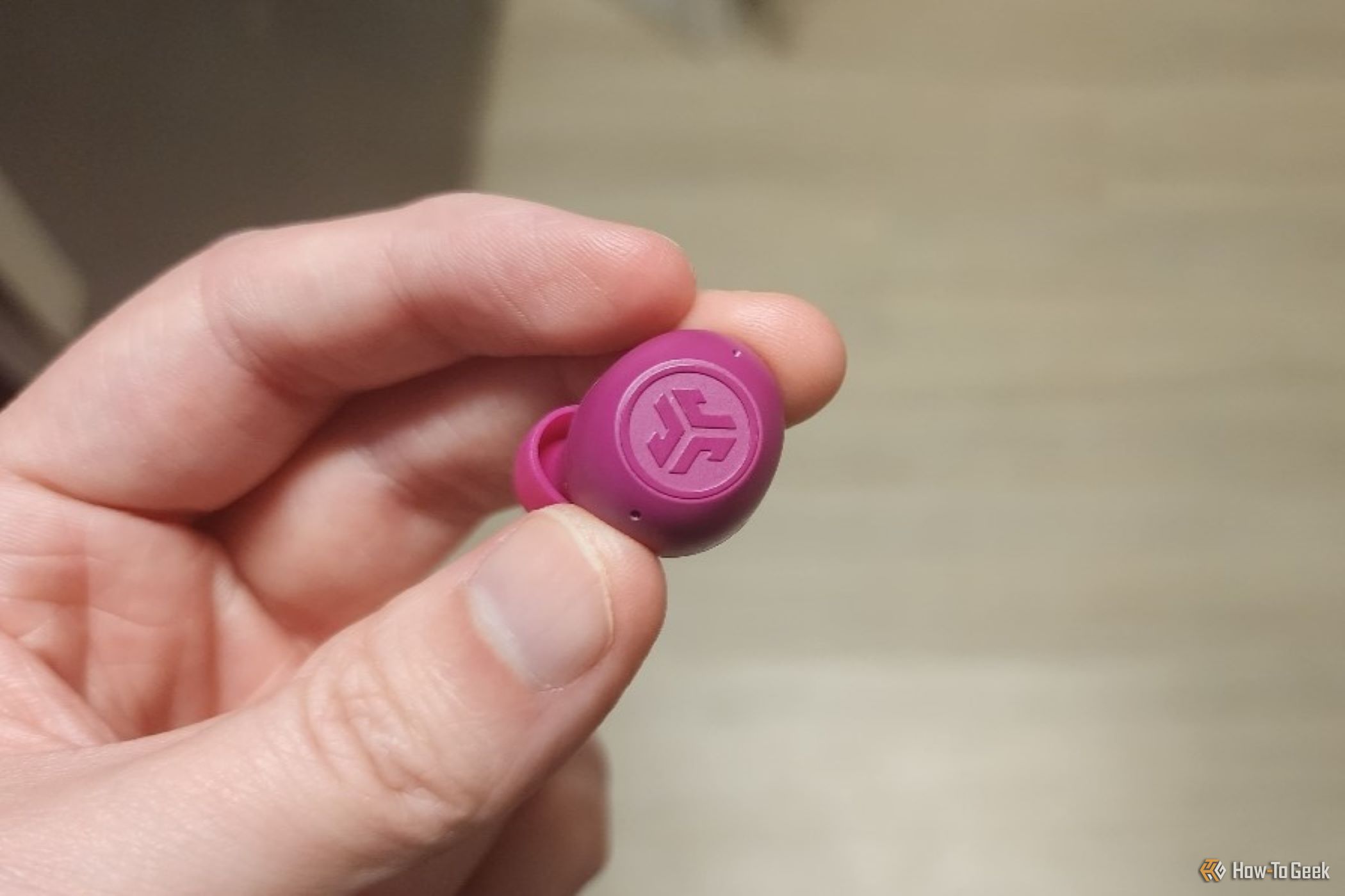 A Fuchsia Jlab Pro Earbud 