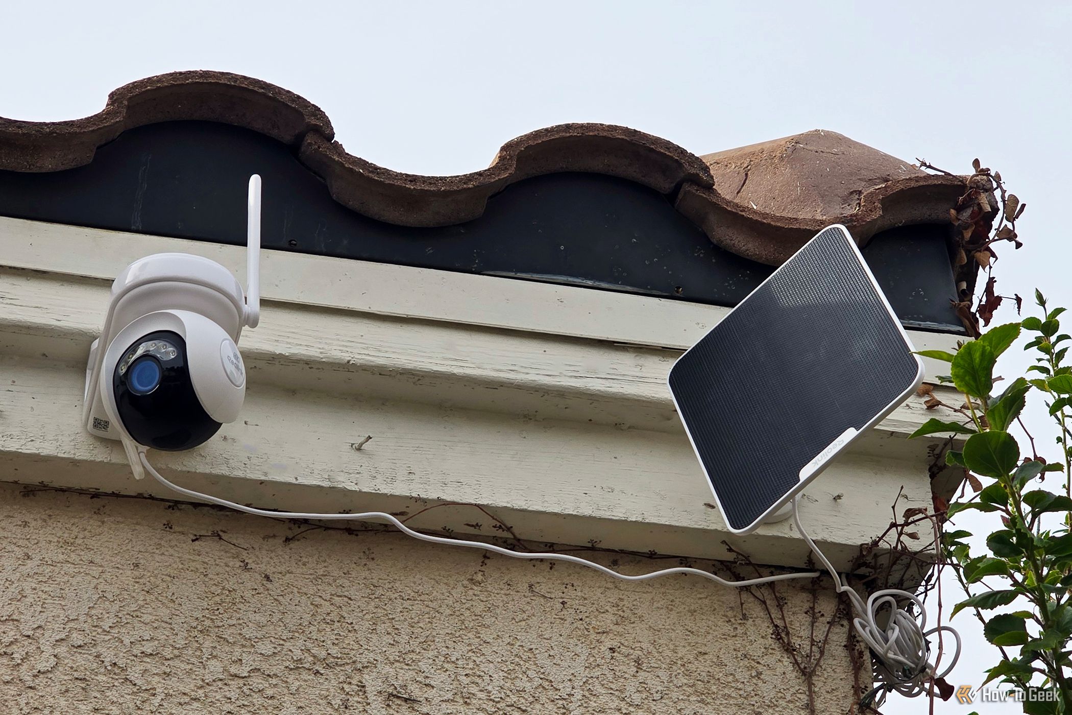 The Reolink Atlas PT security camera and 6W solar panel on the front of a house