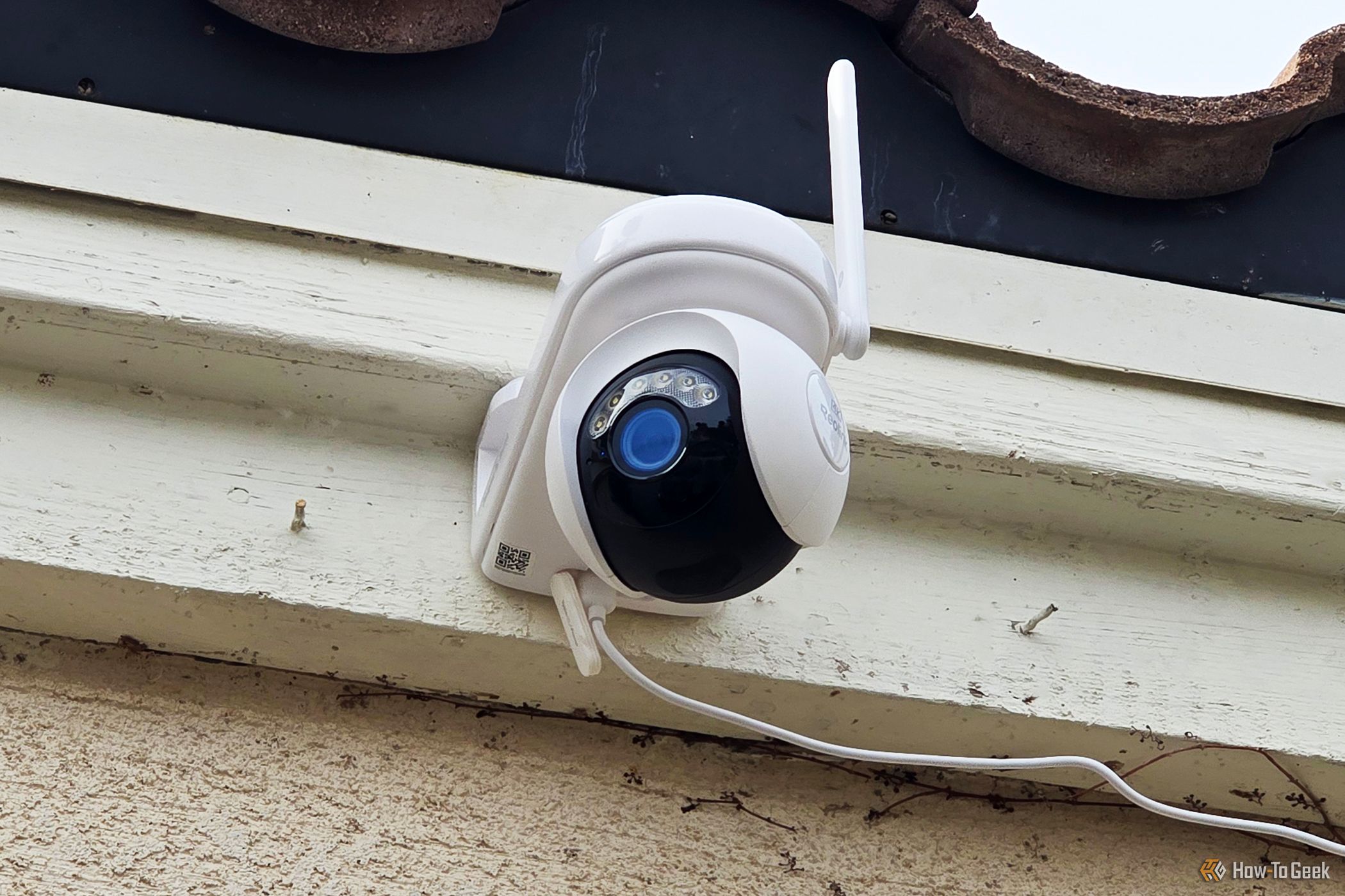 The Reolink Atlas PT security camera on the front of a house