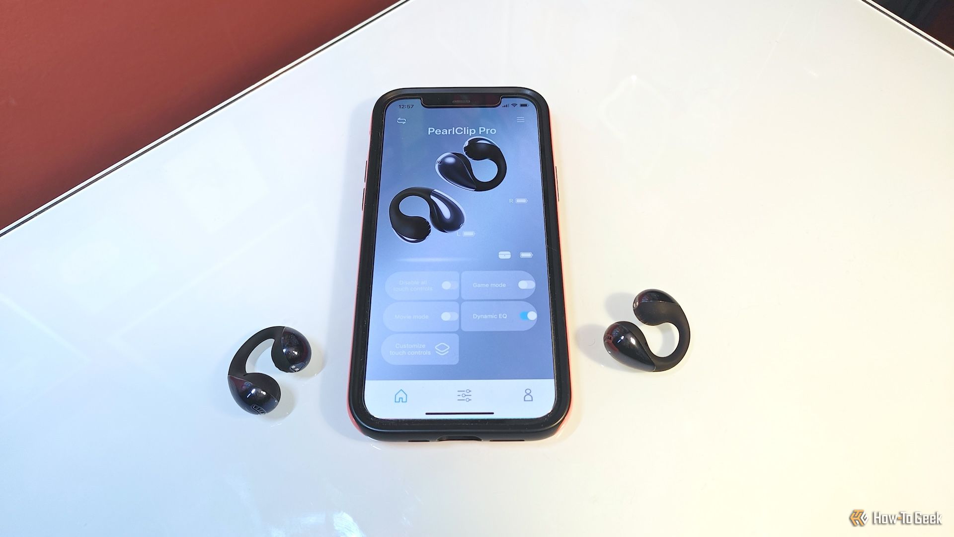 SoundPeats PearlClip Pro earbuds with smartphone displaying PeatsAudio app.