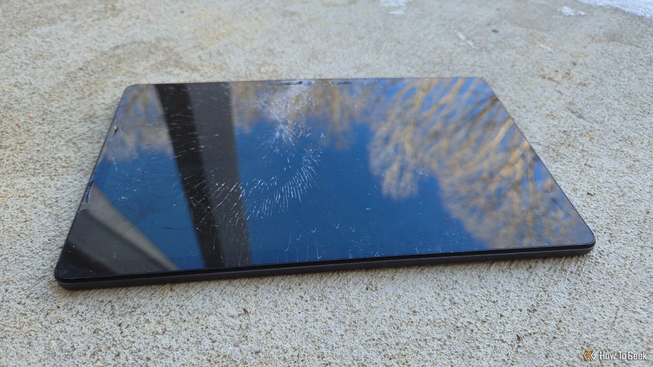 A broken tablet on a concrete porch.