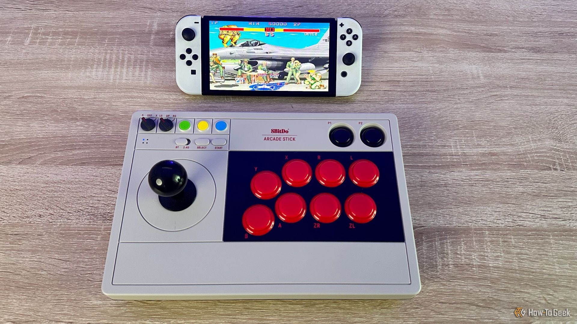 The 8BitDo Arcade Stick for Switch playing Street FIghter 2 on an OLED Nintendo Switch.