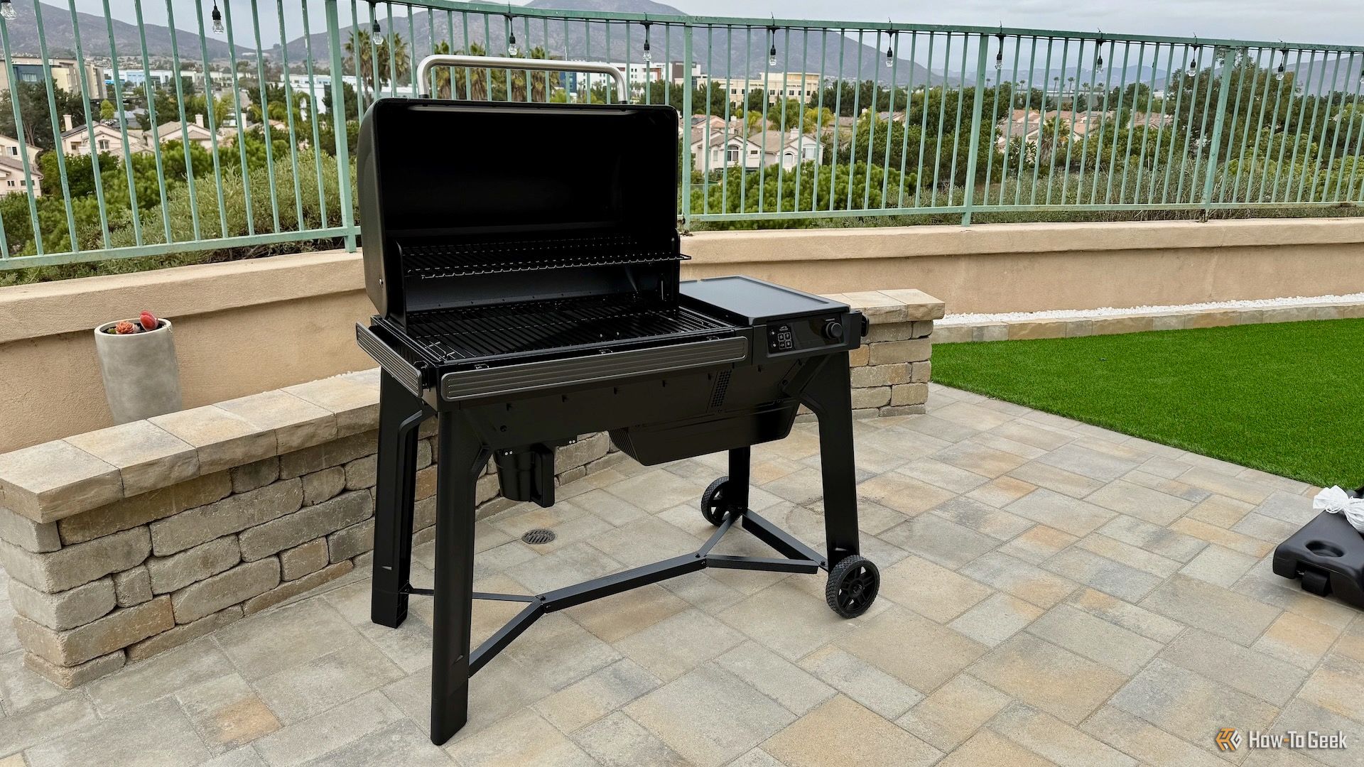 Full view of Traeger Woodridge in a backyard with lid open.