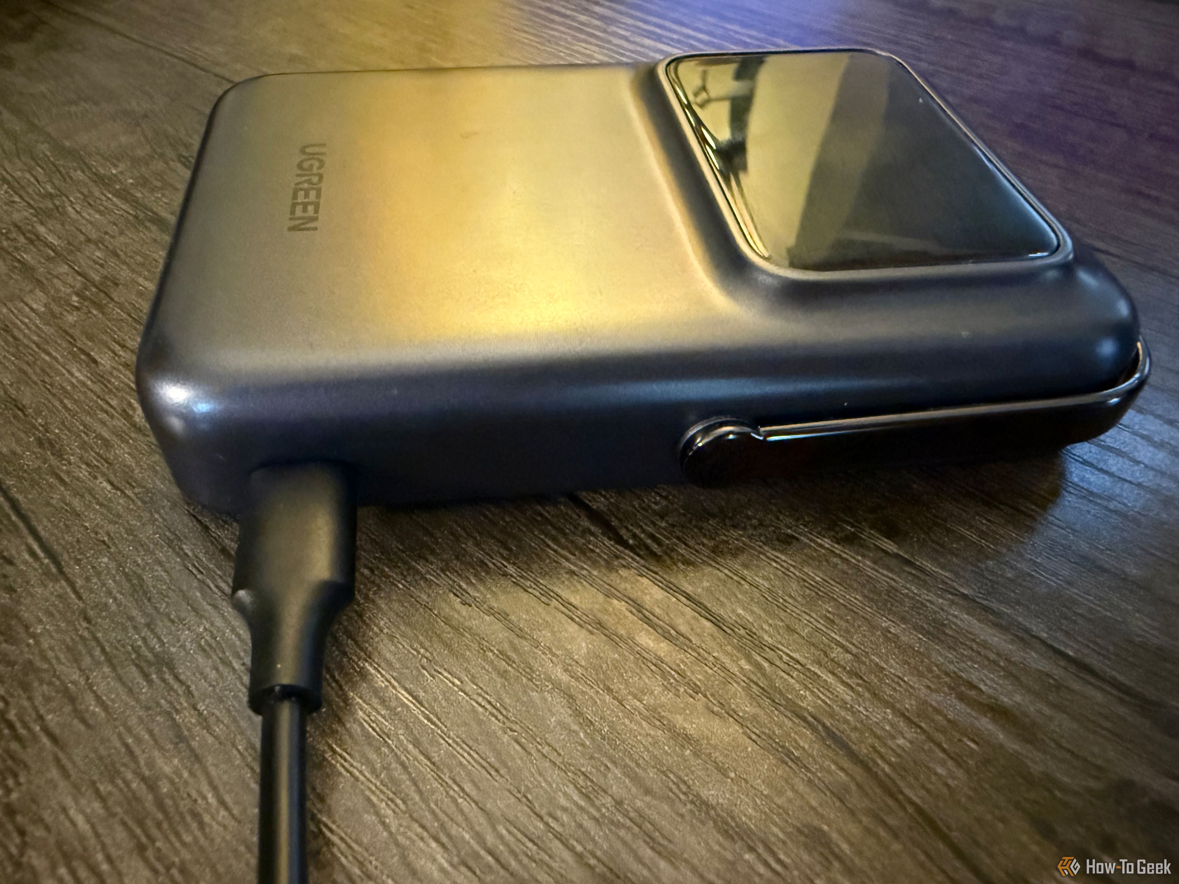 The Ugreen Uno Wireless Power Bank with a USB-C cord plugged in.