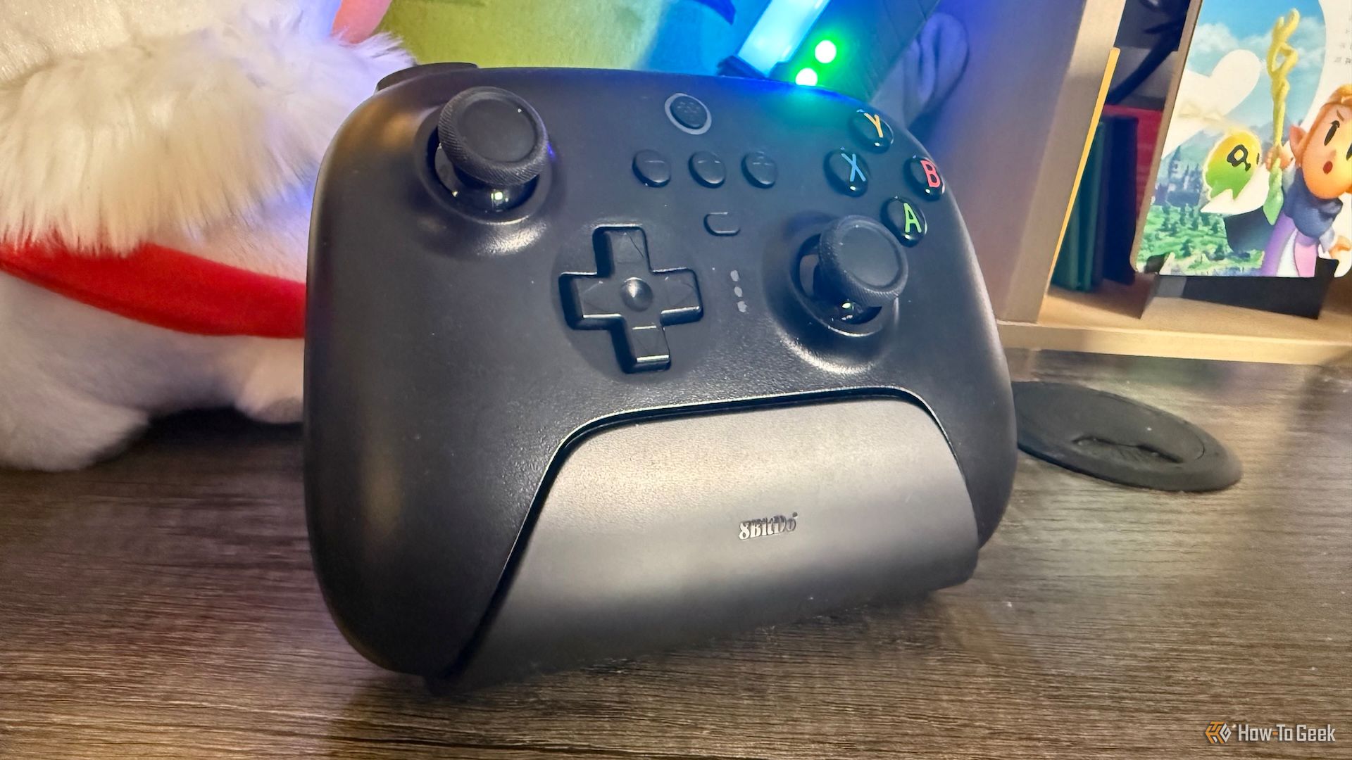 8BitDo Ultimate 2.4G Controller on its dock on a table from an angle.