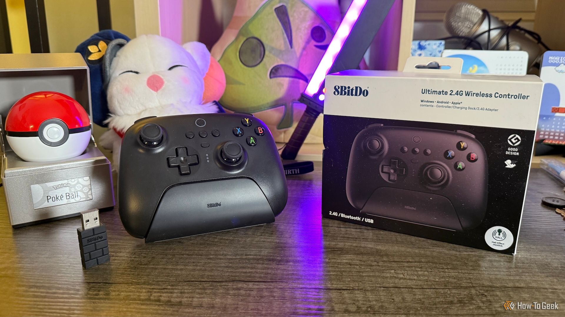 8BitDo Ultimate Wireless Controller with its dock, 2.4 GHz receiver, and packaging.