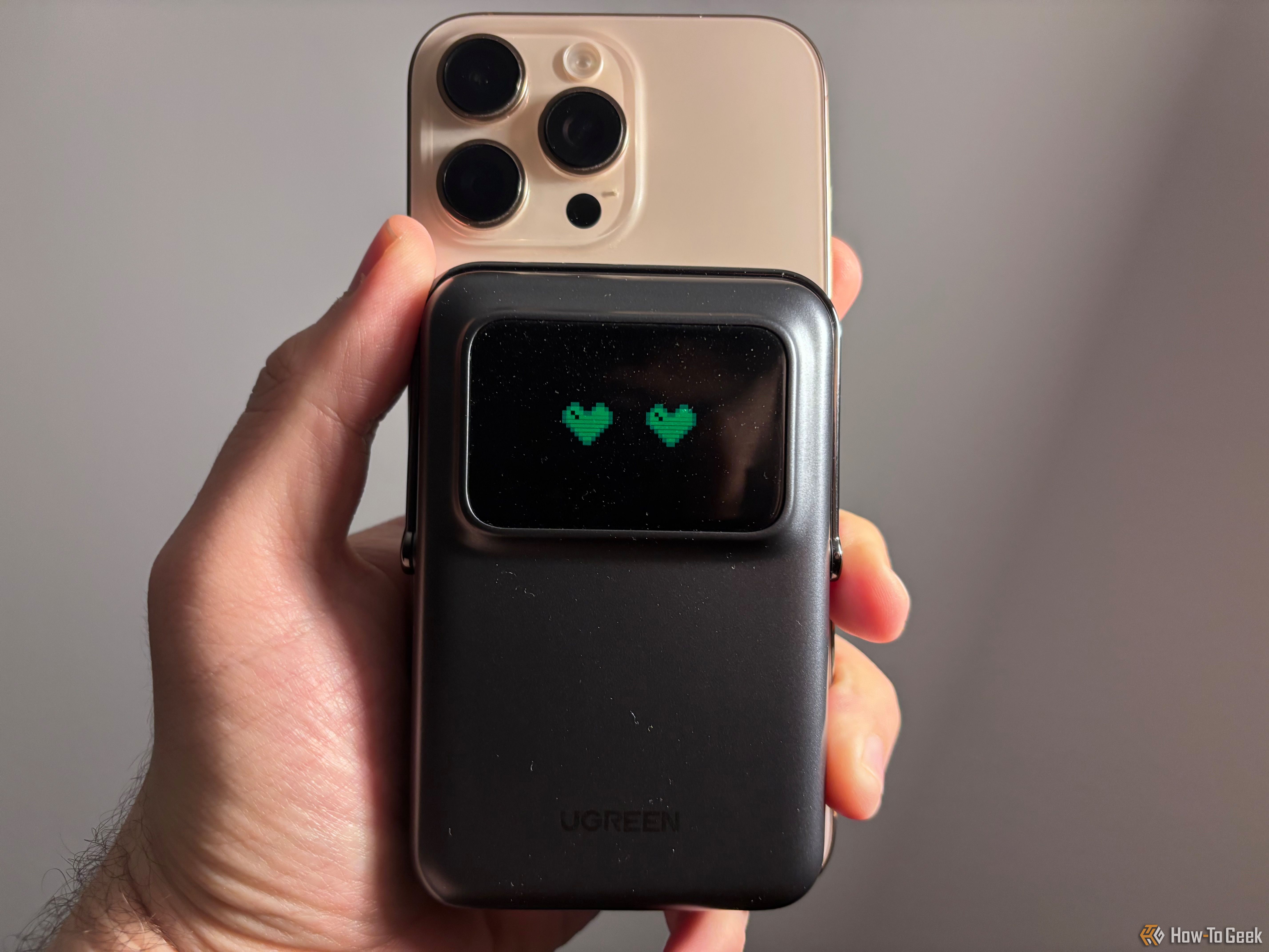 Ugreen Uno Wireless Power Bank attached to an iPhone 16 Pro Max emoting heart eyes.