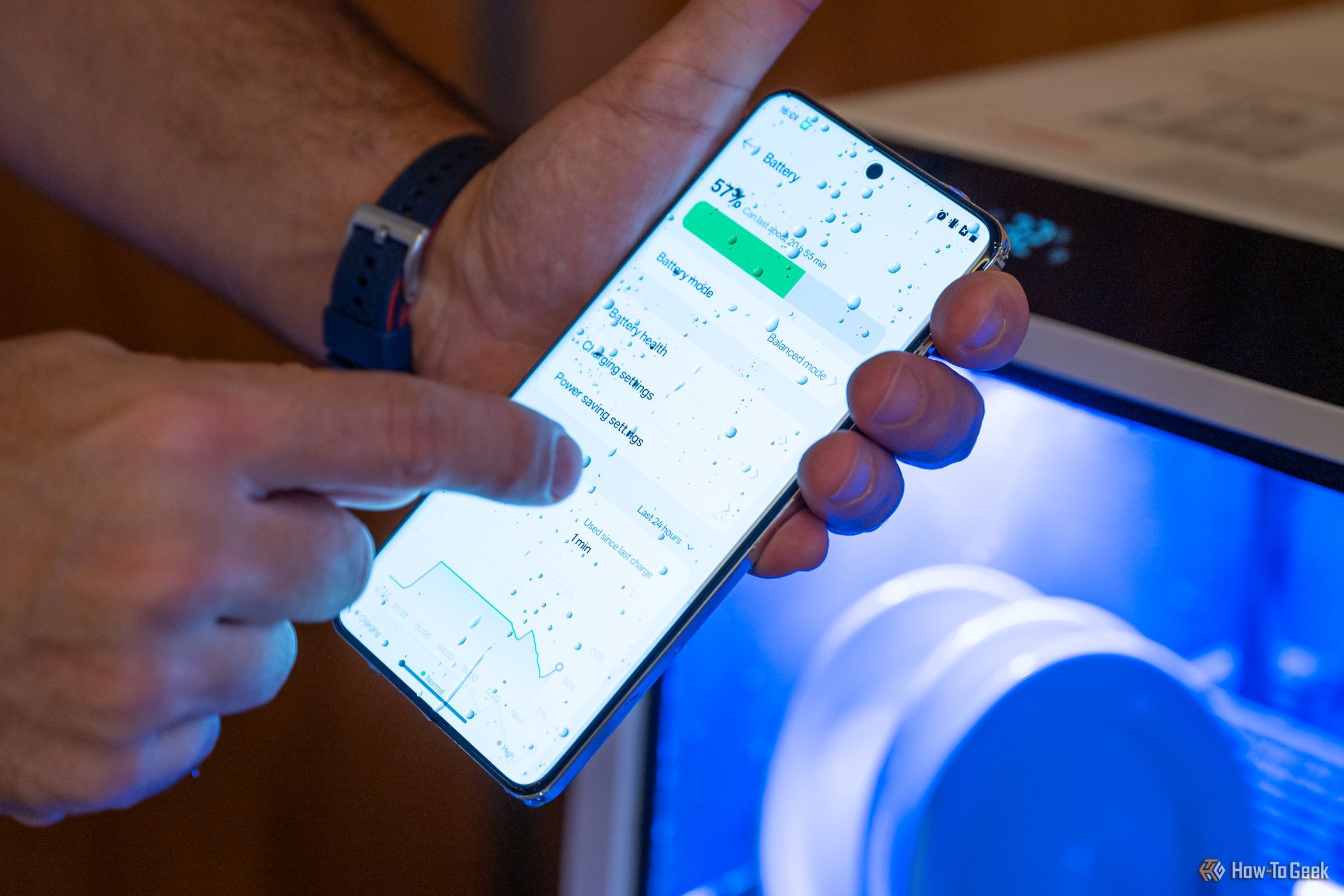 Person using the OnePlus 13 screen covered in water.