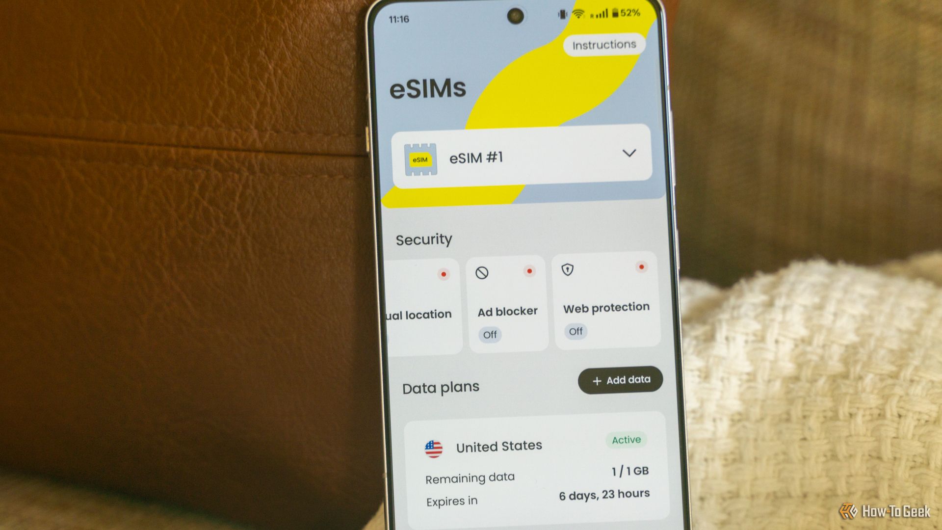 The home page of Saily's eSIM app on a OnePlus 13R sitting on a couch. 