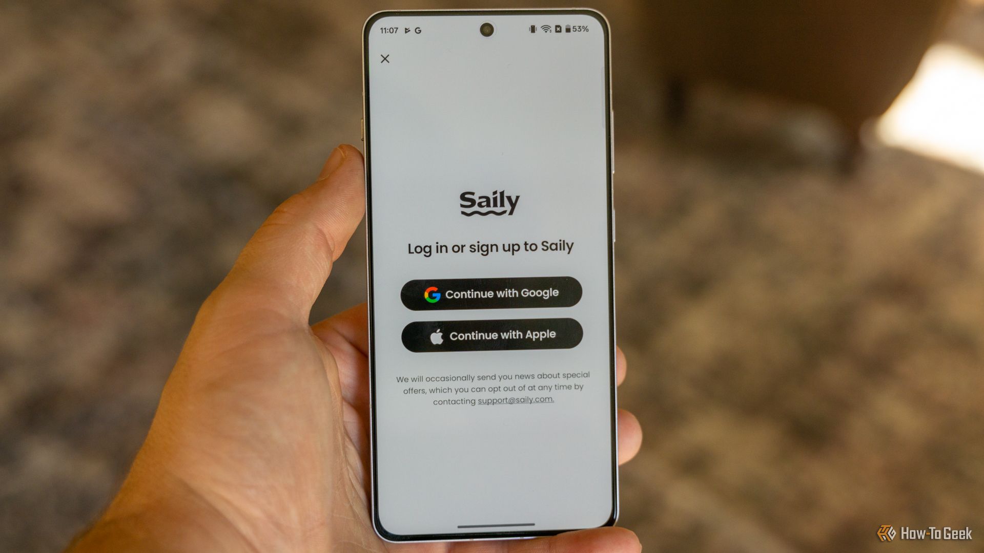 The Saily eSIM app opened on to the login page on a OnePlus 13R.