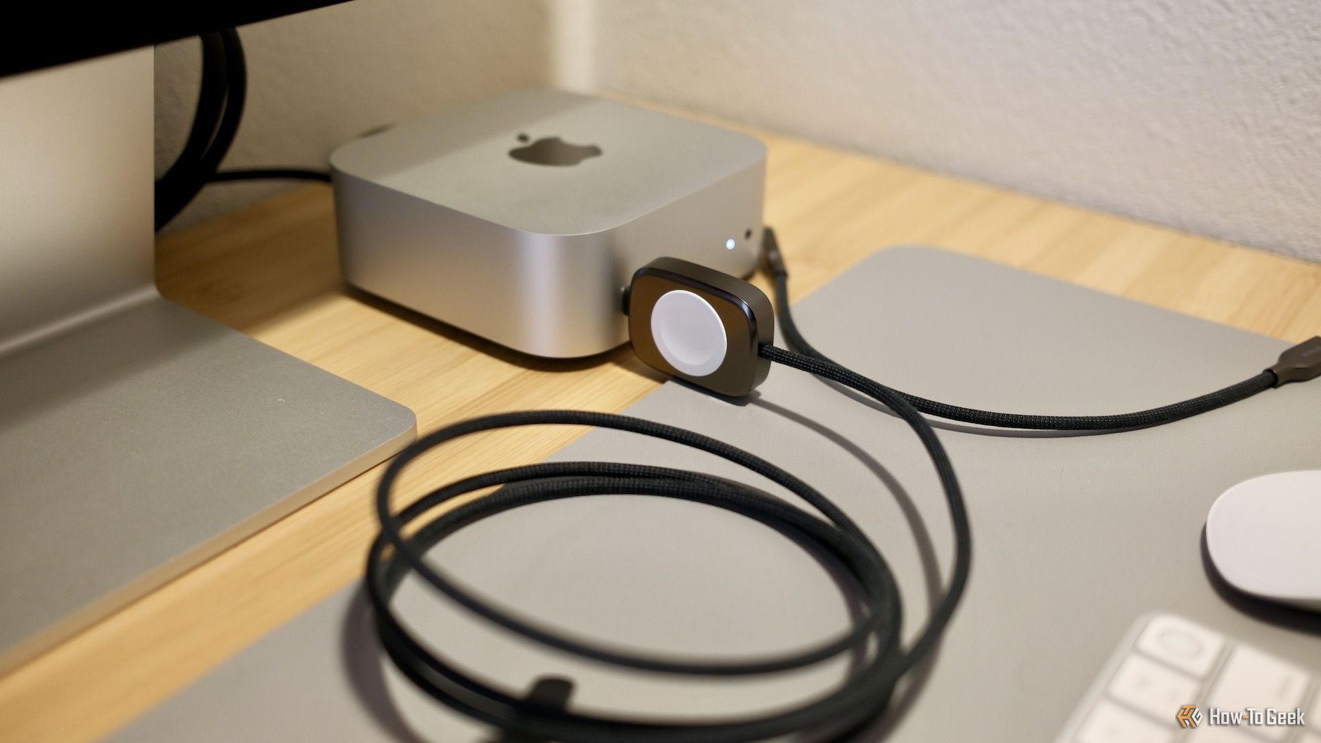 The Nomad hybrid Apple Watch and USB-C charger plugged into a Mac mini. M4.