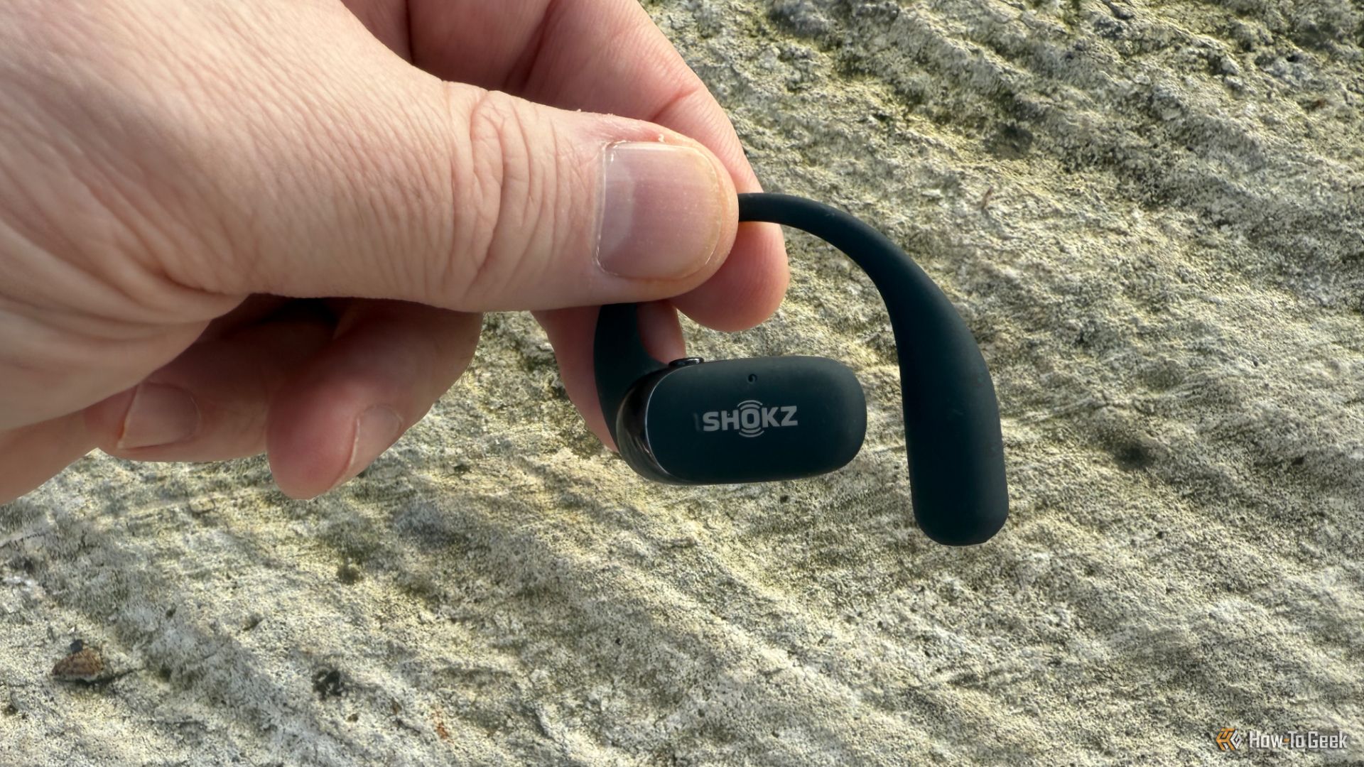 The Shokz OpenFit 2 in a hand