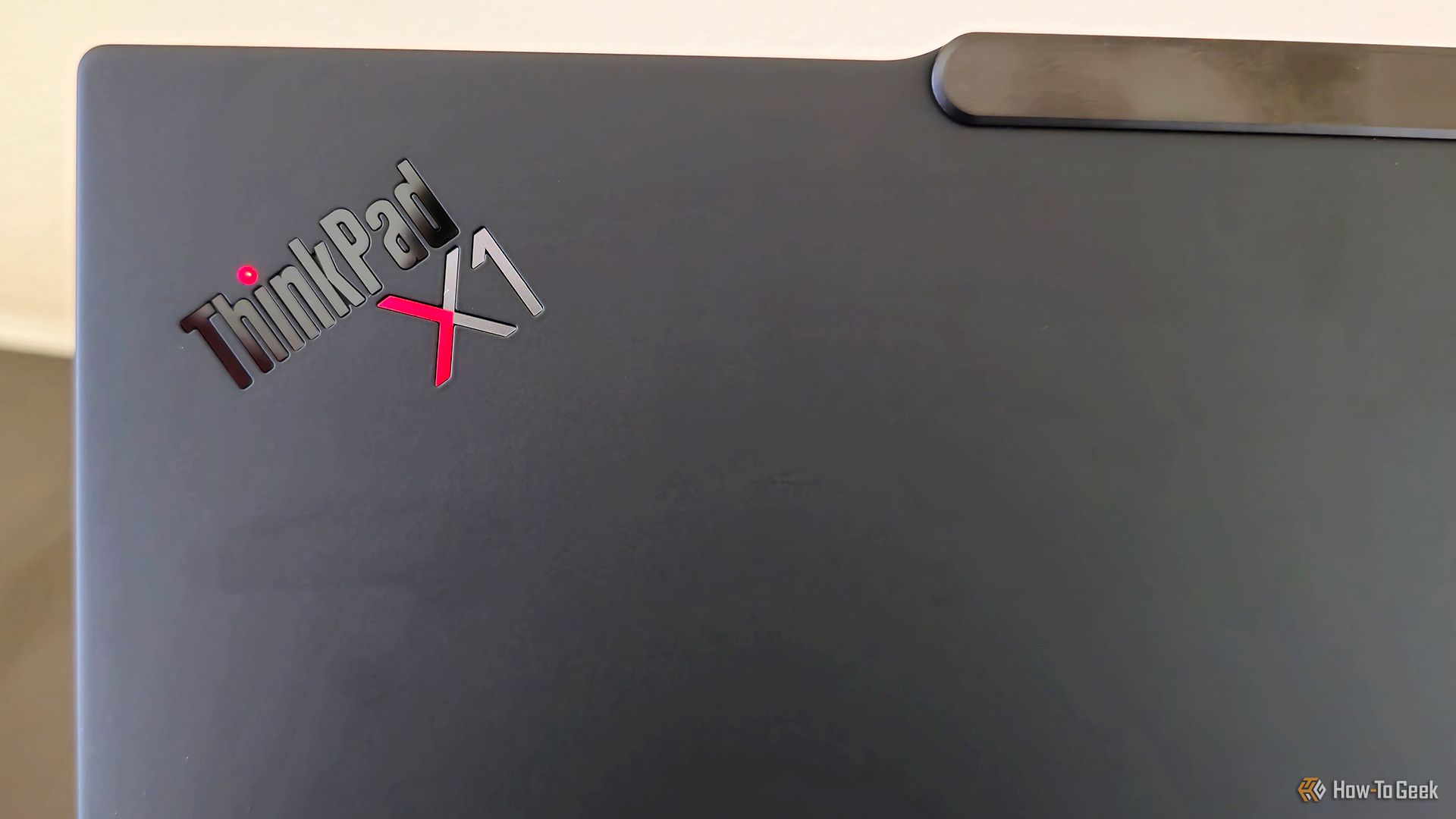 The back ThinkPad logo on the Lenovo ThinkPad X1 Carbon Gen 13 Aura Edition laptop.