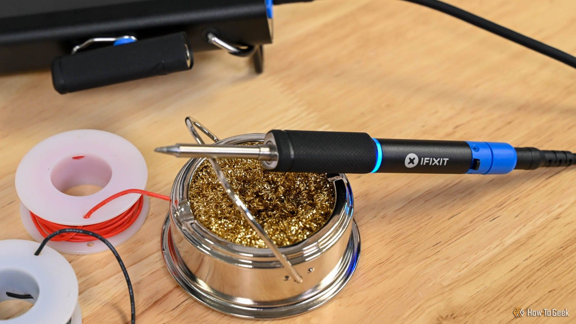 The iFixit FixHub Portable Soldering Iron on a cleaner stand