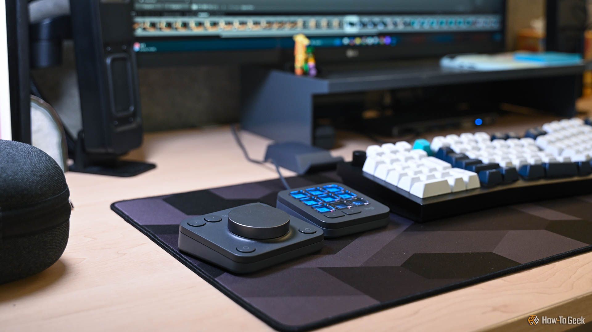 The MX Creative Console on a desk with Adobe open on the computer.