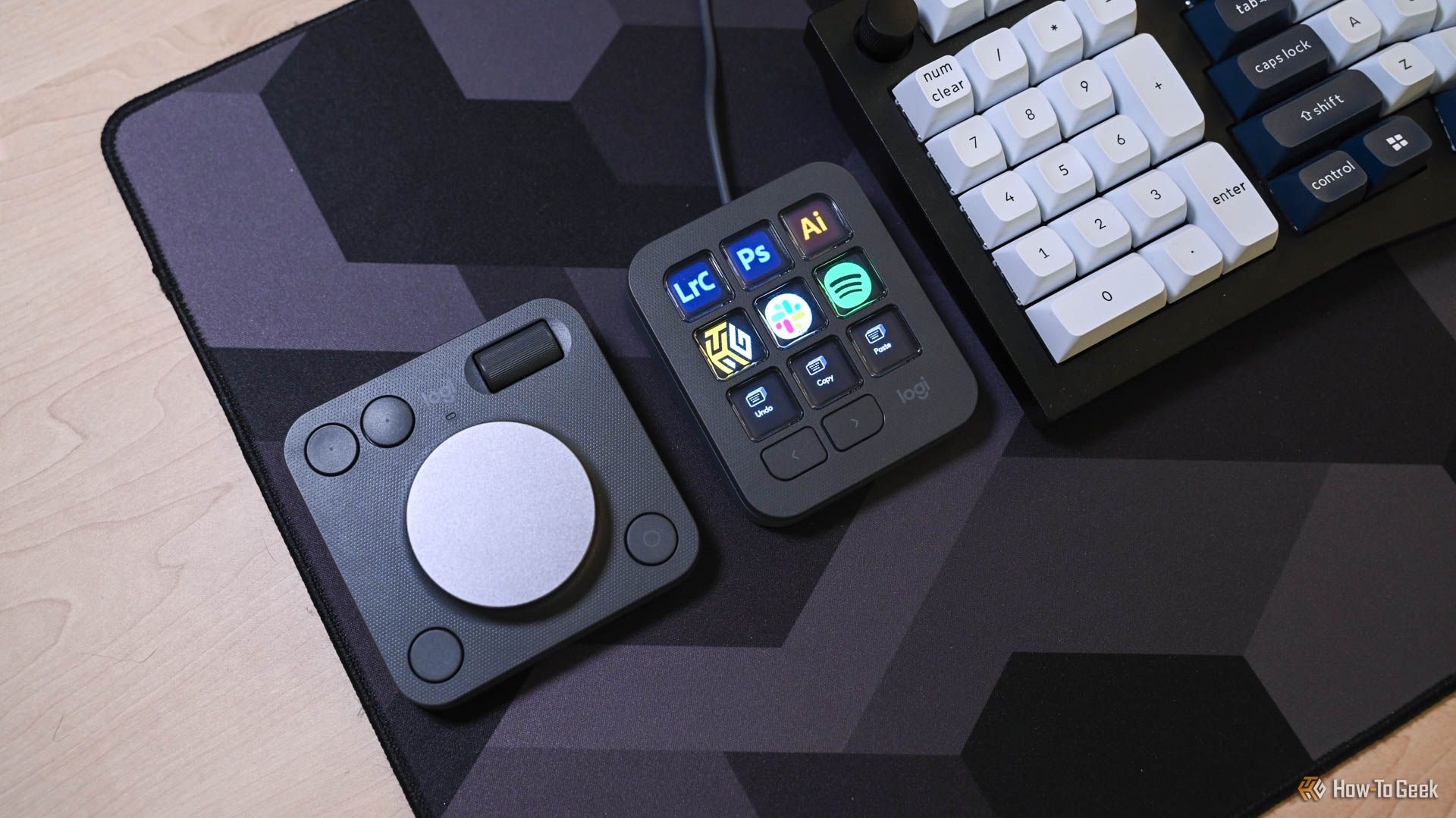 The MX Creative Keypad on a desk next to the MX Creative Dialpad.