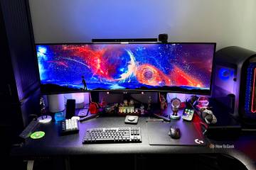 INNOCN 49Q1R 49-Inch OLED Curved Gaming Monitor on a desktop with accessories.