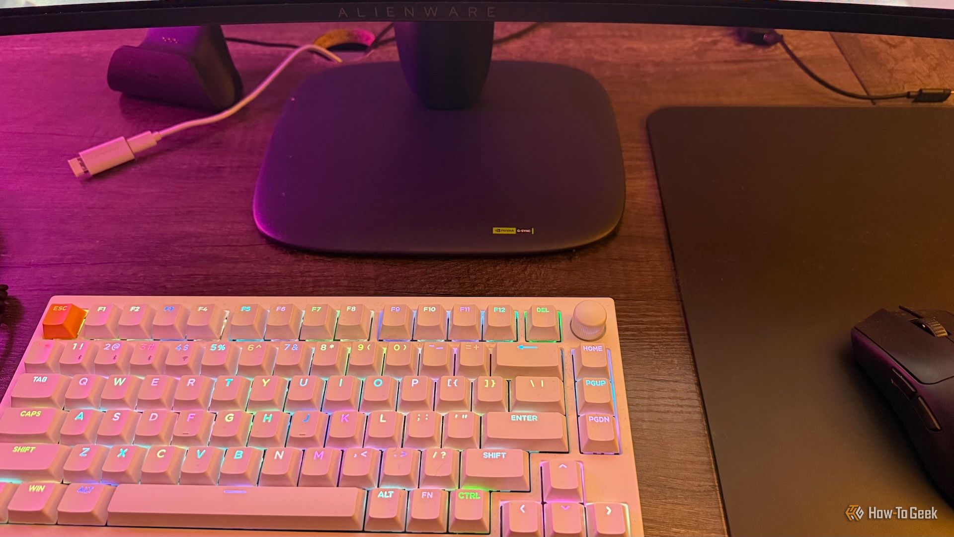 The base of the Alienware AW3425DW curved ultrawide gaming monitor, with a Keychron P1 HE and a Razer Viper V3 Pro.