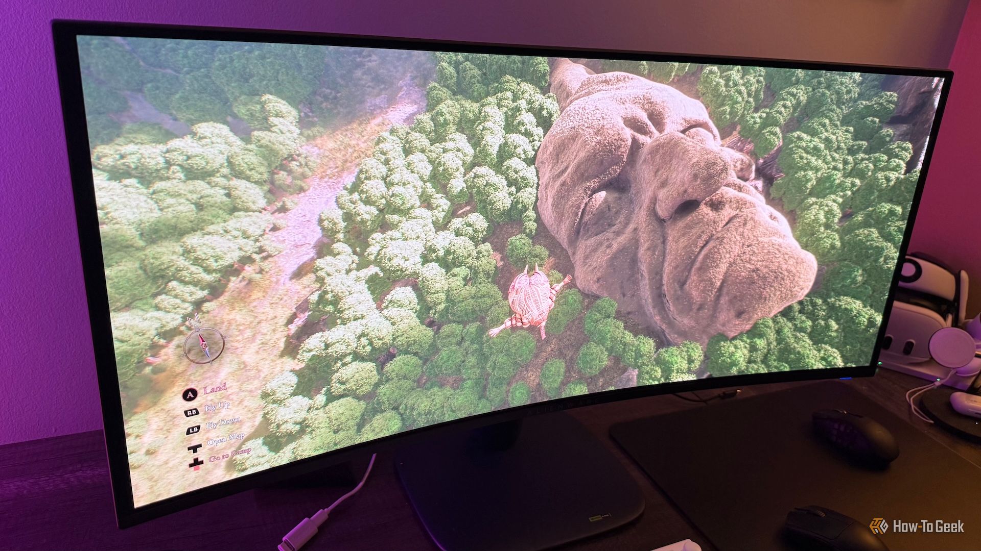 An Alienware AW3425DW curved ultrawide gaming monitor with Esquie flying over a face in the overworld of Clair Obscur: Expedition 33 on it.