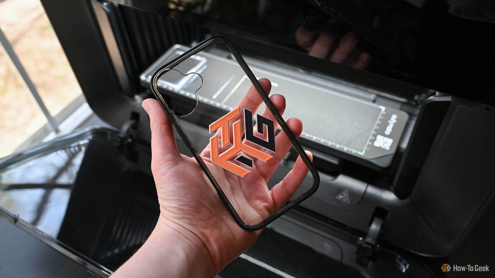 Person holding a phone case printed on by the EufyMake E1 UV Printer.