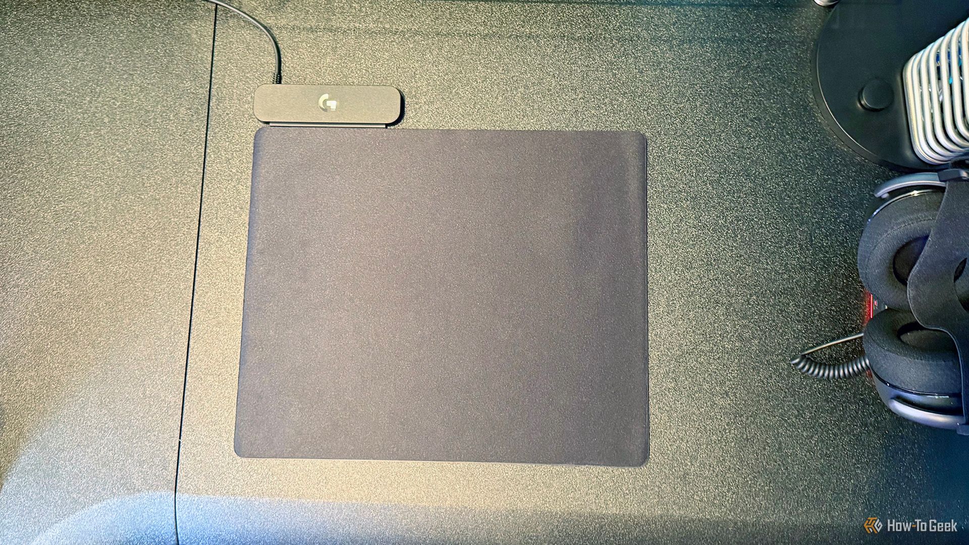 Logitech G Powerplay 2 Wireless Charging System on a black desk.