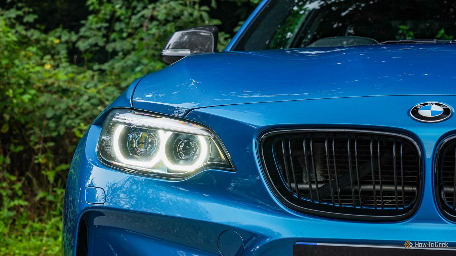 Close-up shot of the kidney grills and LED headlight on a blue 2018 BMW M2.