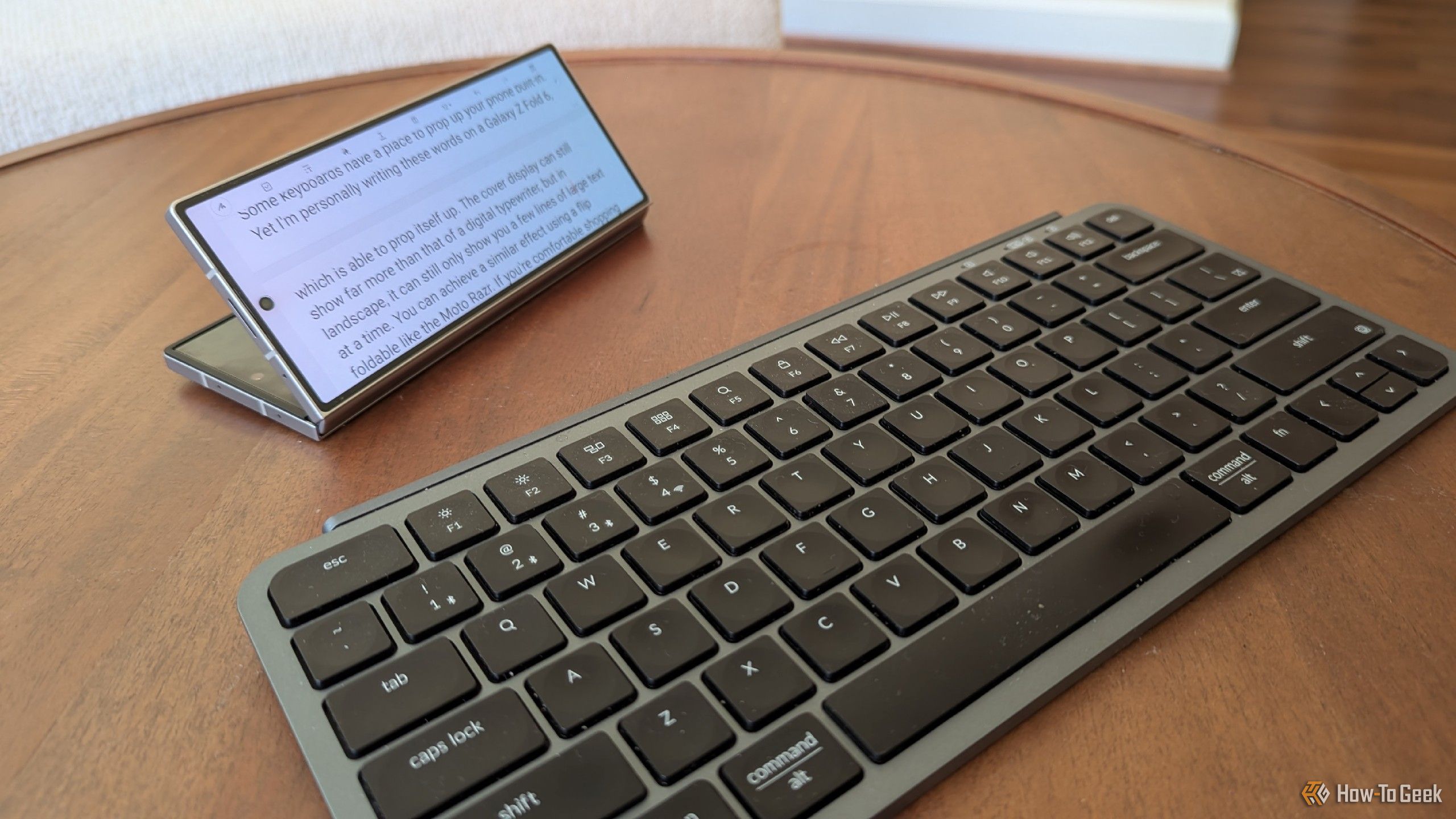 A Bluetooth keyboard issued to a Galaxy Z Fold 6 that is partially folded.