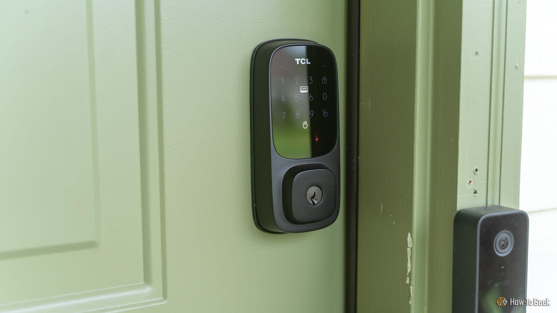 A close up of the TCL D1 Pro palm vein smart lock with the keypad illuminated.