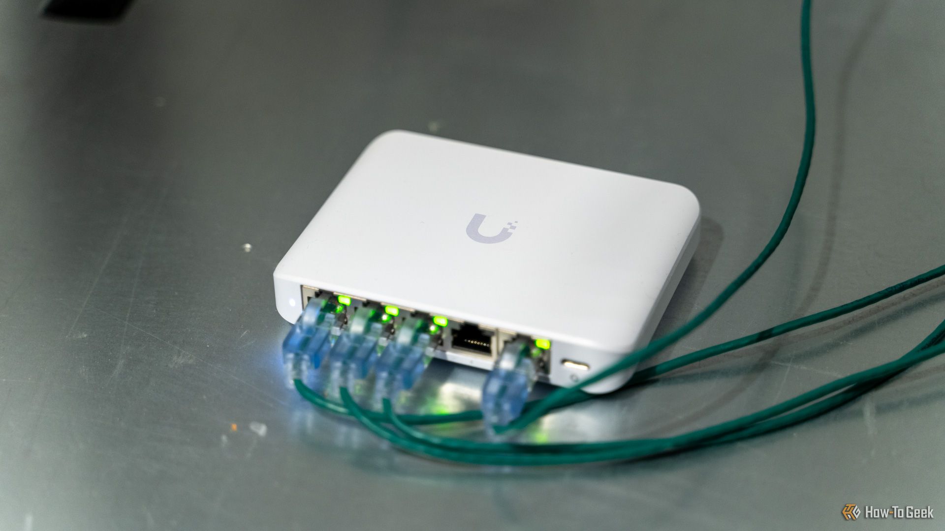 The Unifi Flex Mini 2.5G Ethernet switch with cables plugged in sitting on a server.
