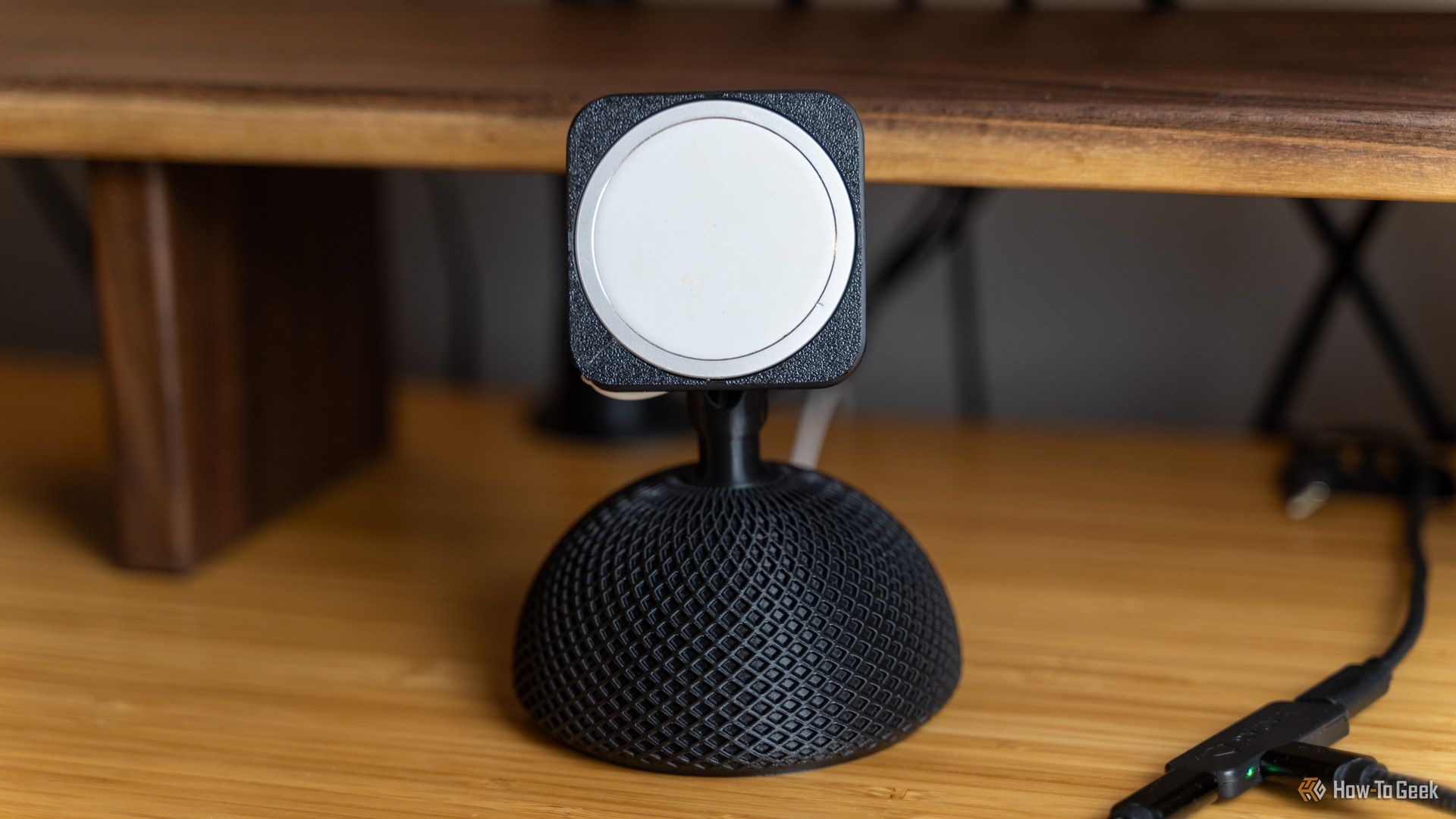 An iMac-inspired 3D printed MagSafe phone mount sitting on a bamboo desk.