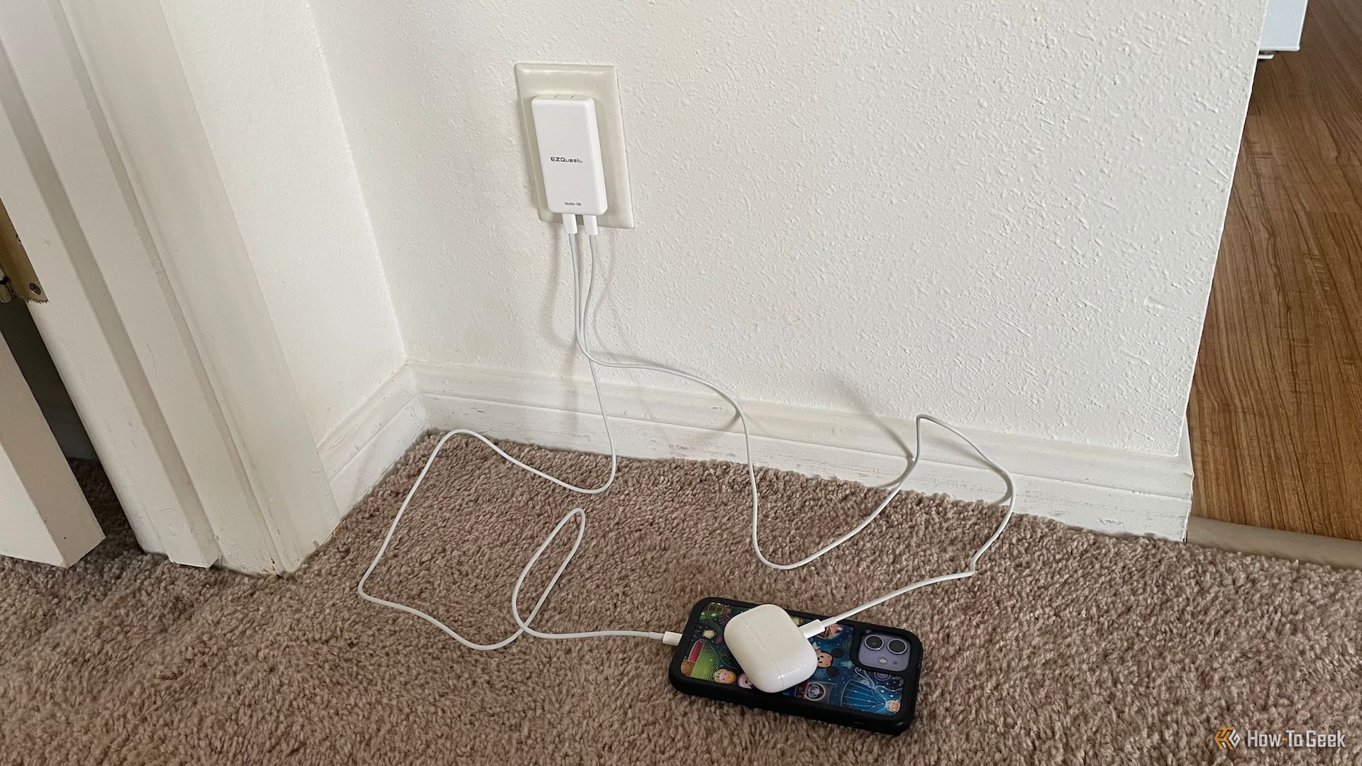 The EZQuest UltraSlim 70W Wall Charger being used to charge an iPhone and an AirPods Pro 2 case.
