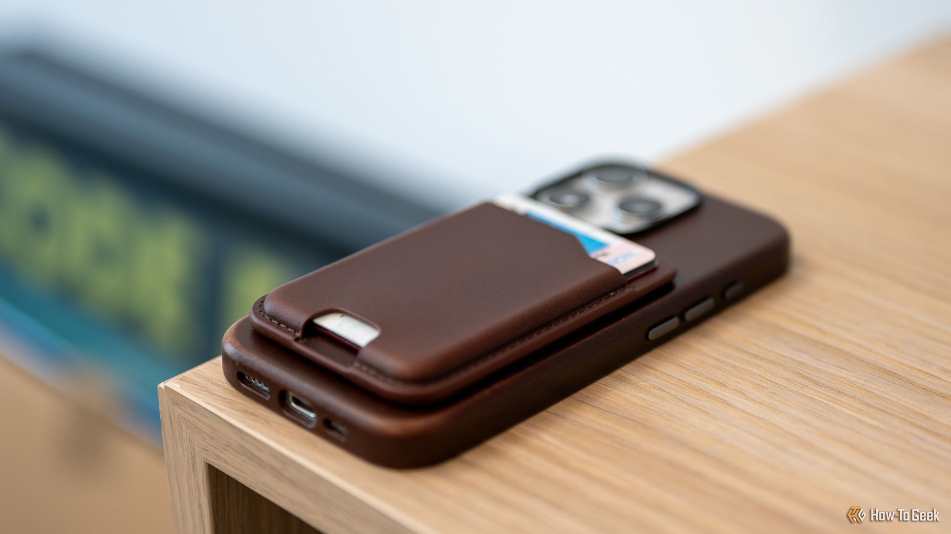 Nomad Leather Mag Wallet attached to an iPhone laying on a table.-1