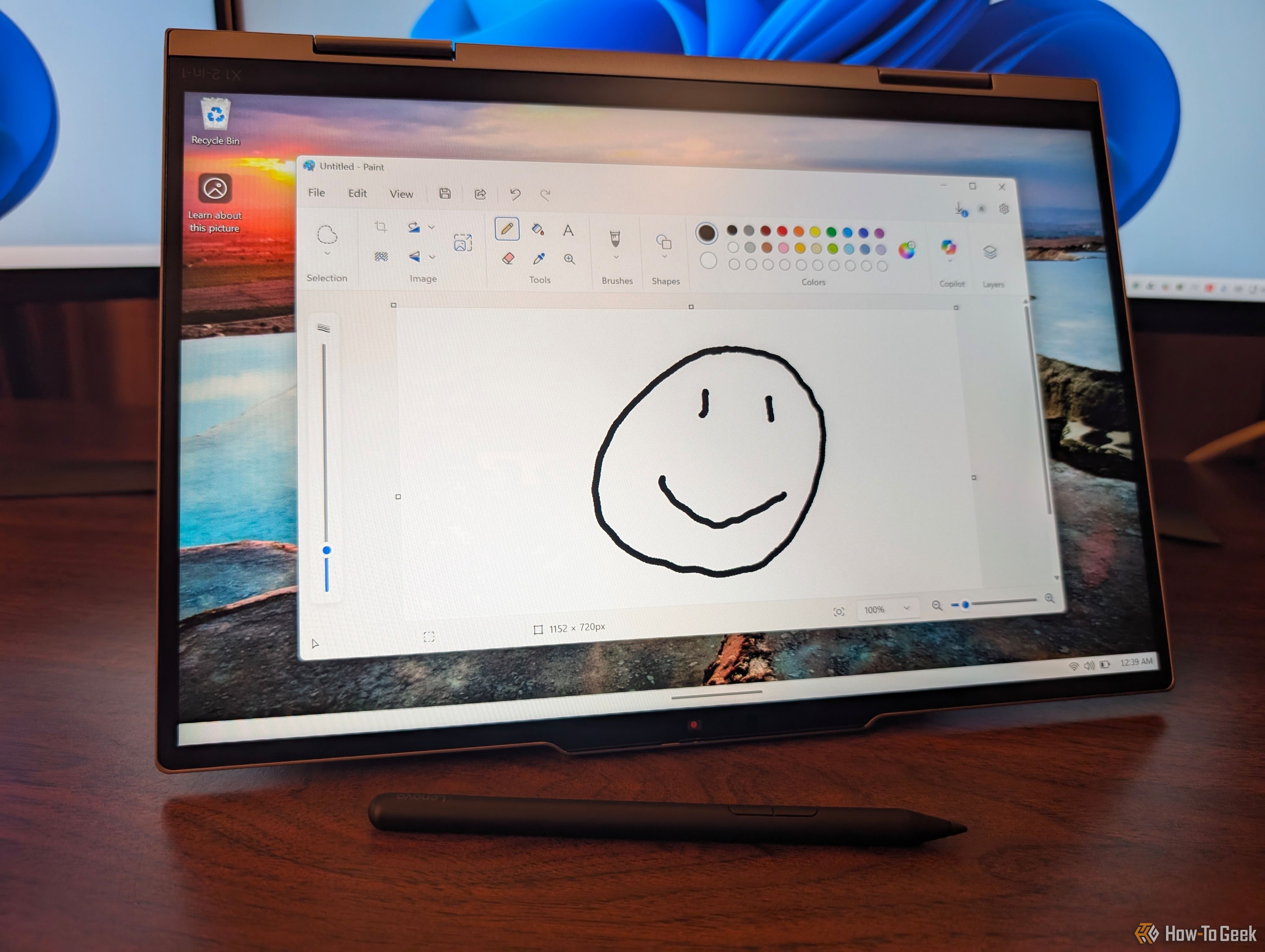 The laptop folded into an A shape with a doodle on it.