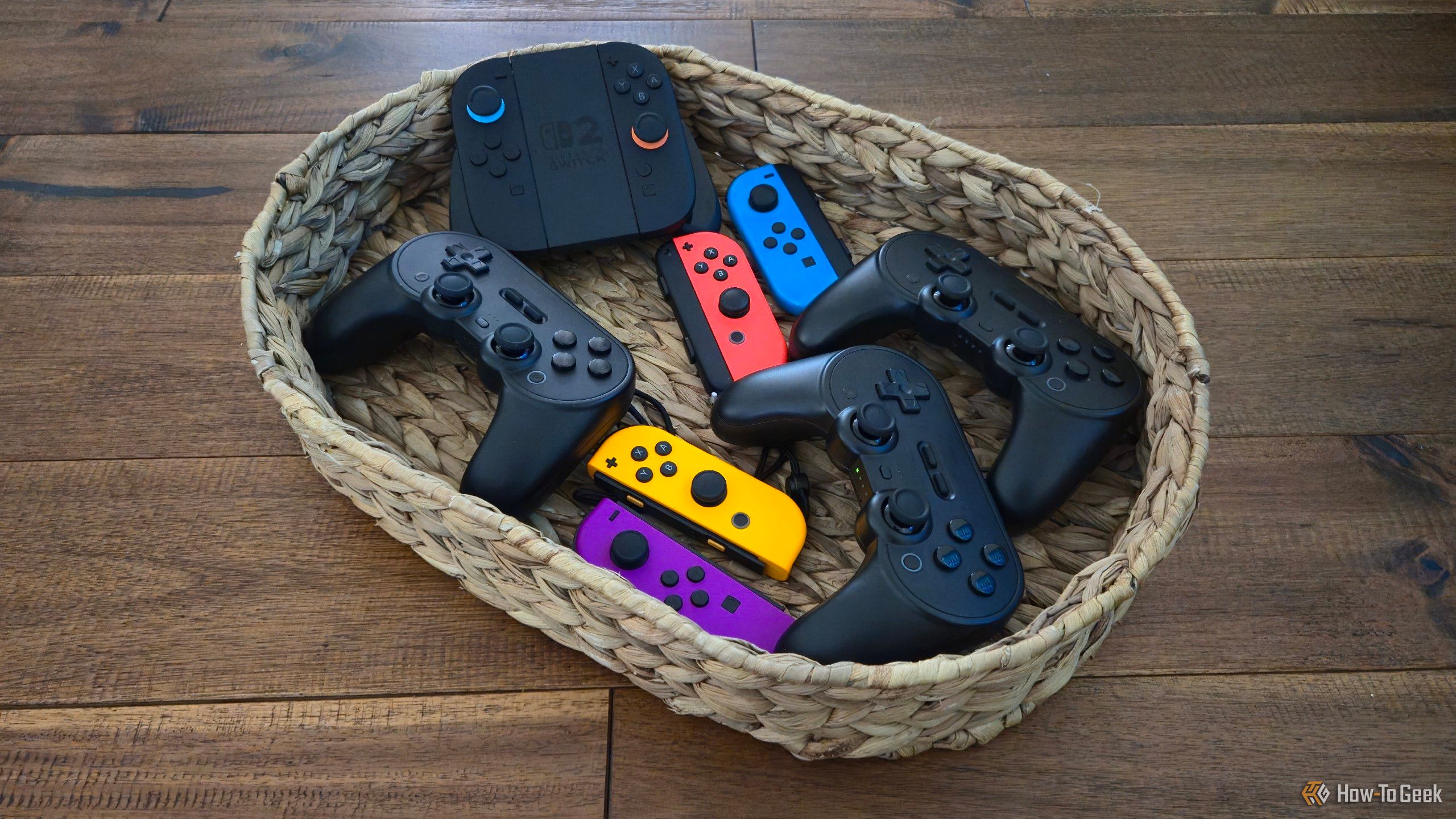 Several Joy-Cons and 8BitDo Pro 2 controllers in a basket.