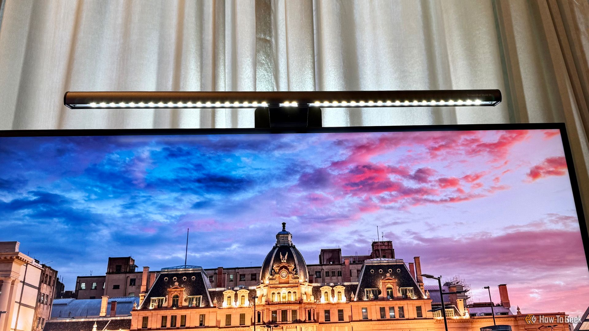 View of the underside of the BenQ ScreenBar Halo 2 on top of a monitor.