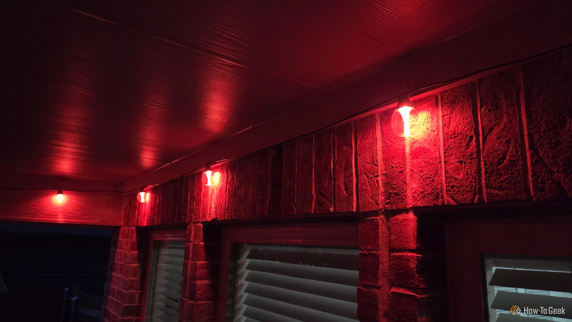 Govee Outdoor Clear Bulb lights shining red in a backyard. 