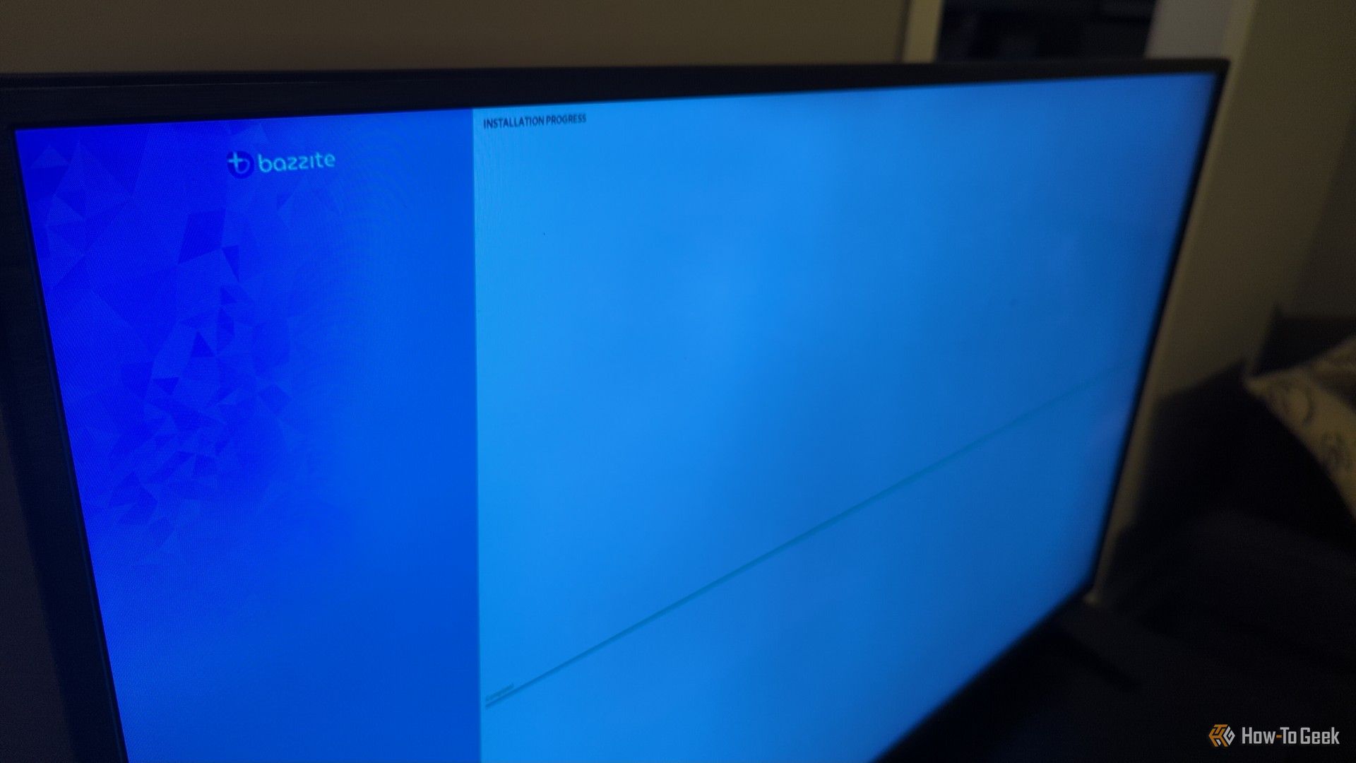 A living room TV with a visible Bazzite installation screen.