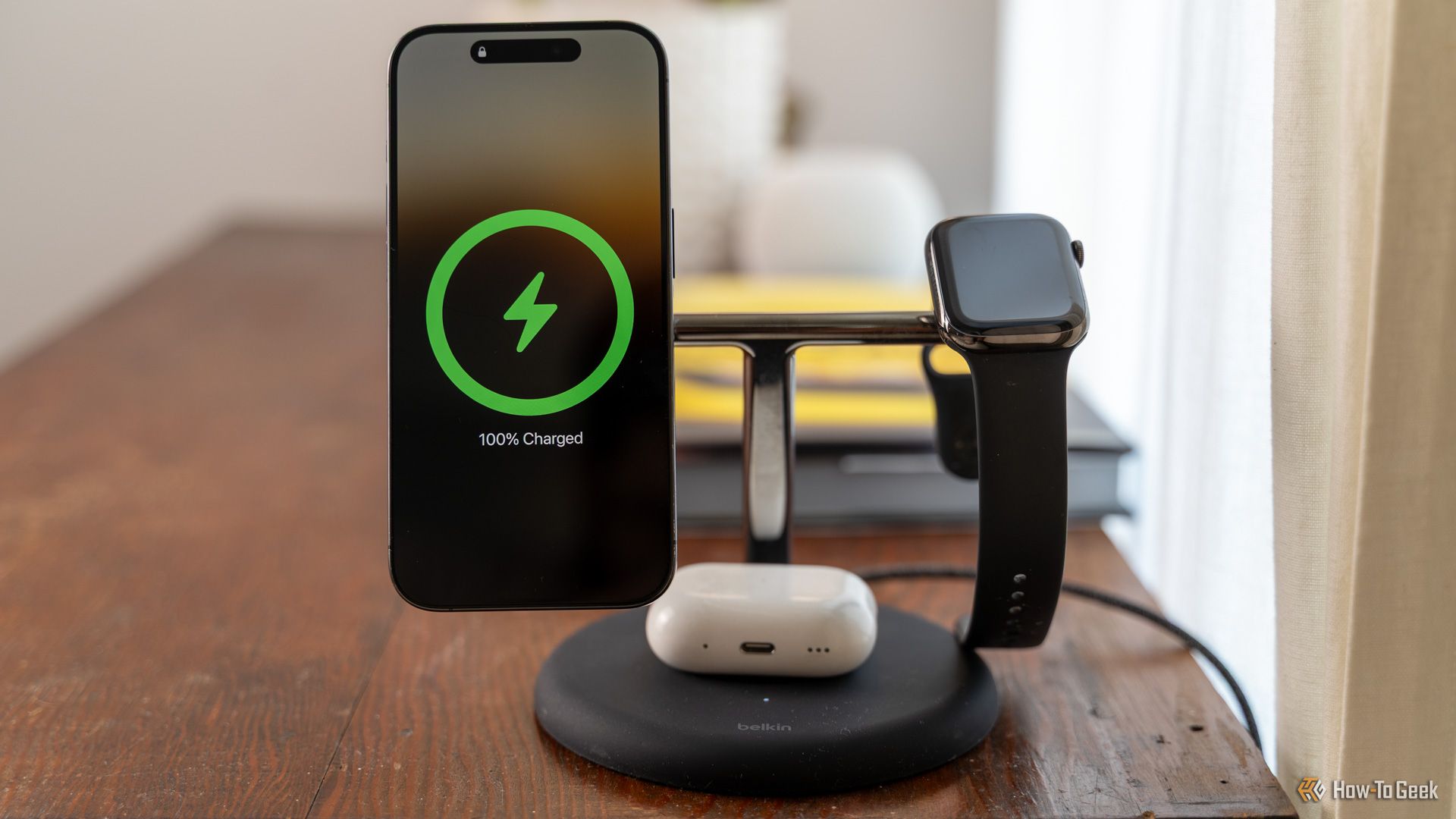 The Belkin BoostCharge Pro 3-in-1 MagSafe charger with an iPhone, Apple Watch, and AirPods charging.