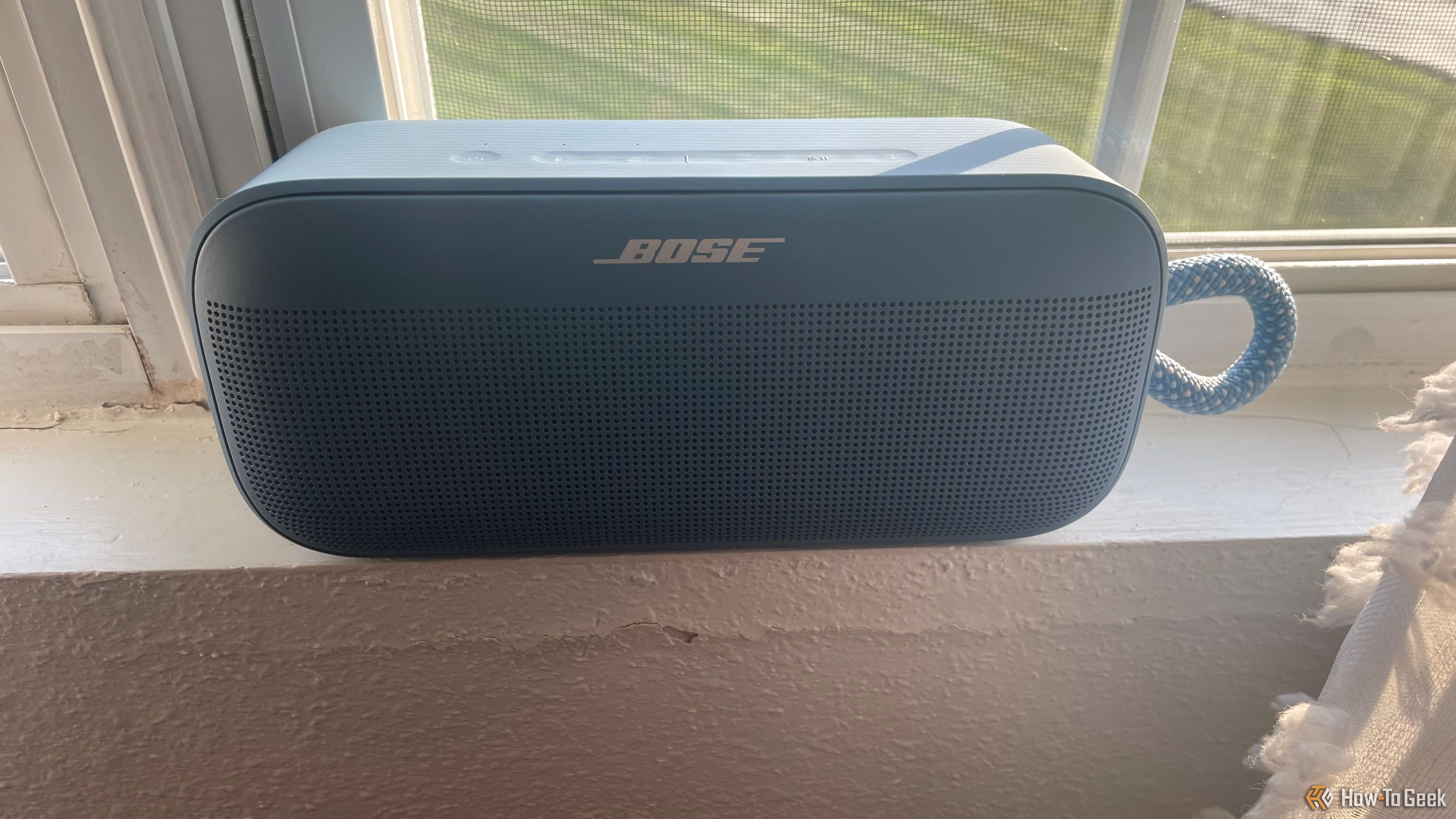 The Bose SoundLink Plus on a window sill.