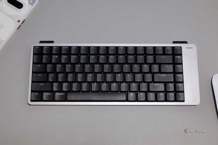 Lofree Flow 2 sitting on a desk next to mouse.