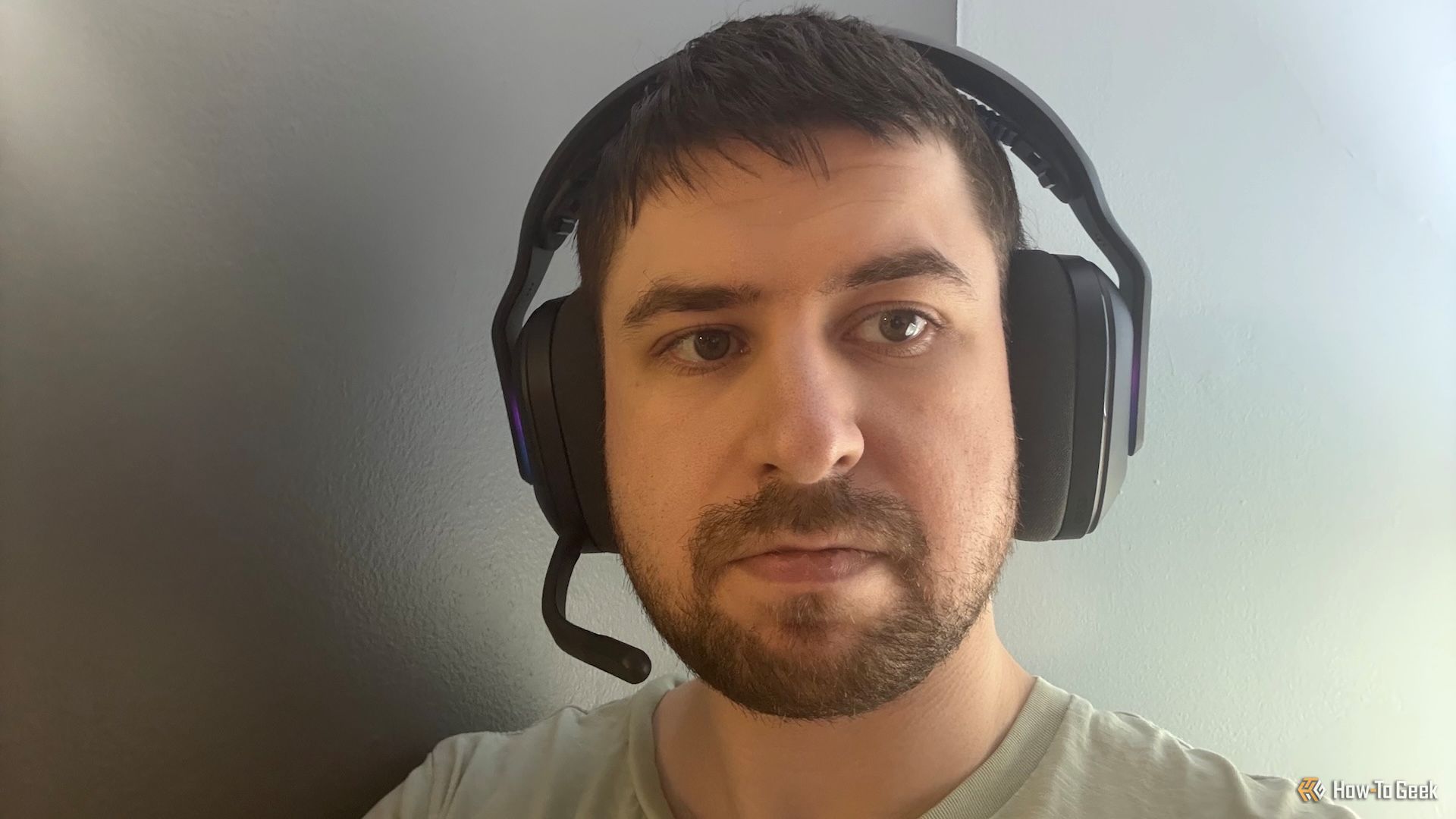 A man wearing the Logitech G522 Lightspeed gaming headset.