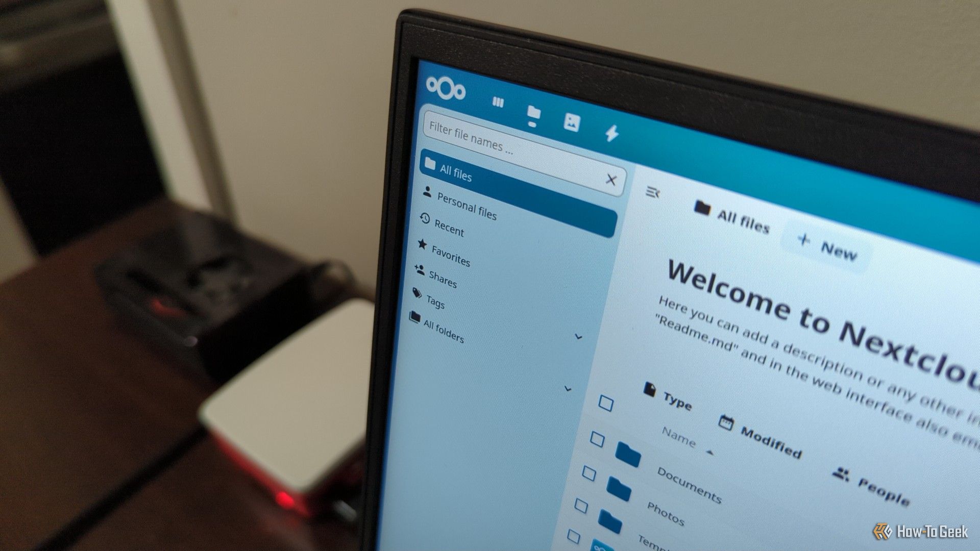 NextCloud interface on a laptop screen with two Raspberry Pi peripherals in the background.