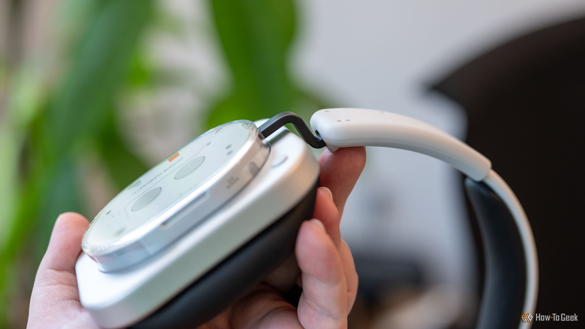 Person holding the Nothing Headphone 1 showing the build and band.