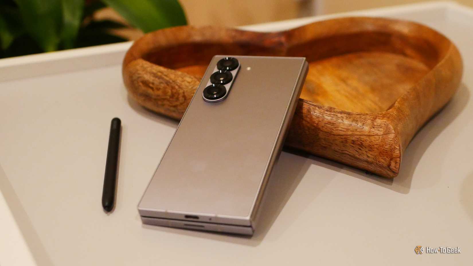 Samsung Galaxy Z Fold 6 resting on a heart-shaped wooden tray.