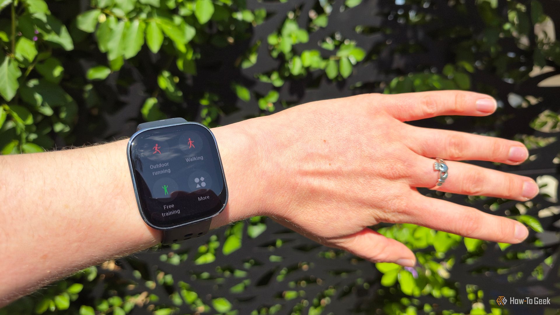 The Amazfit Bip 6 smartwatch on a wrist showing the Sport mode page.